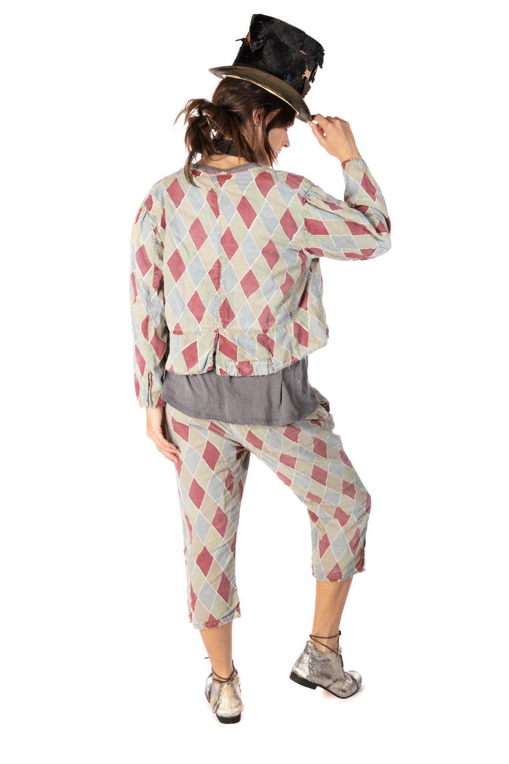 Woman in Magnolia Pearl vintage harlequin artisan clothing with whimsical lace bib and distressed top hat