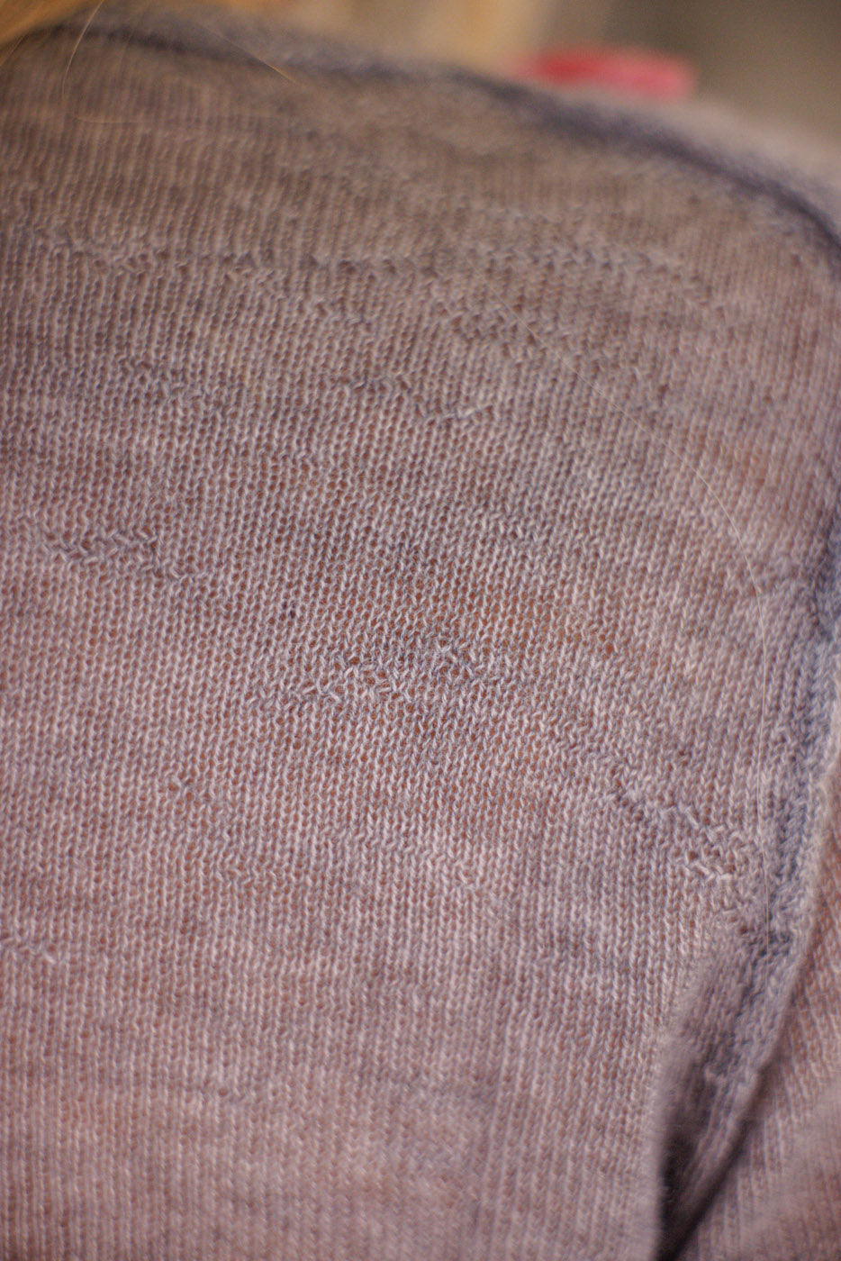 Close-up of gray Magnolia Pearl artisan cashmere knit sweater with subtle vintage texture