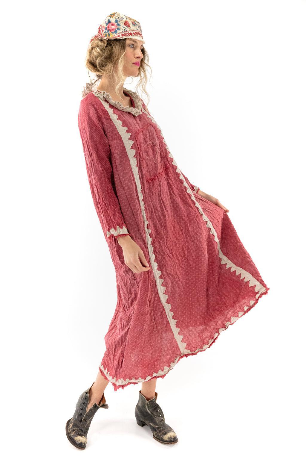 Woman in Magnolia Pearl artisan vintage red dress with whimsical zigzag trim, floral hat, boots