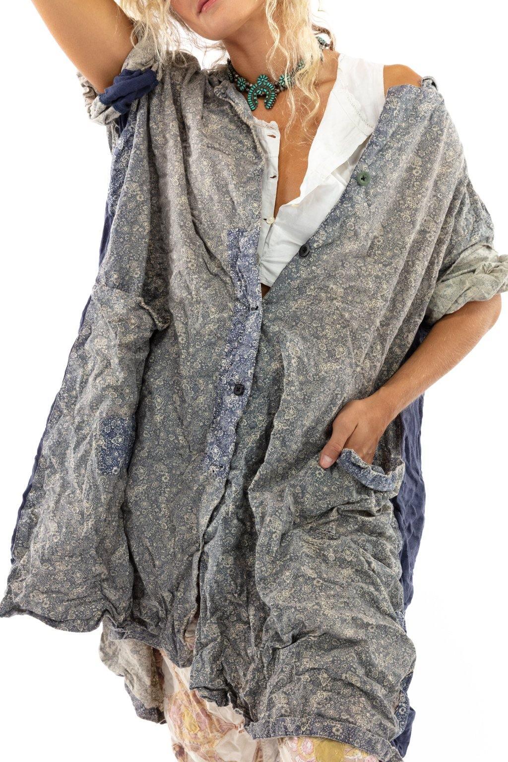 Woman in oversized blue patterned dress, floral pants, yellow embroidered boots, white background