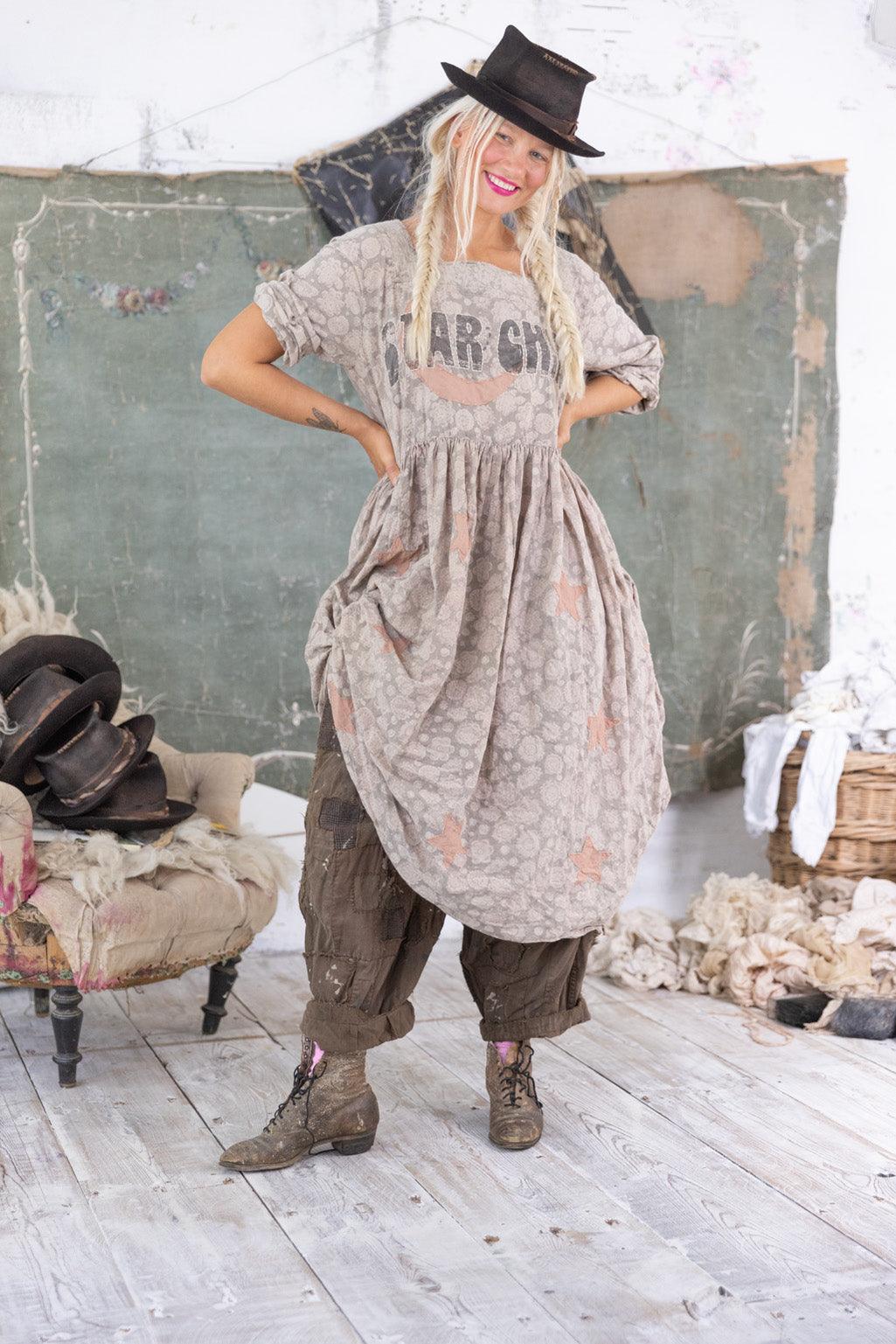 Magnolia Pearl artisan dress with whimsical vintage style, worn by woman in eclectic setting