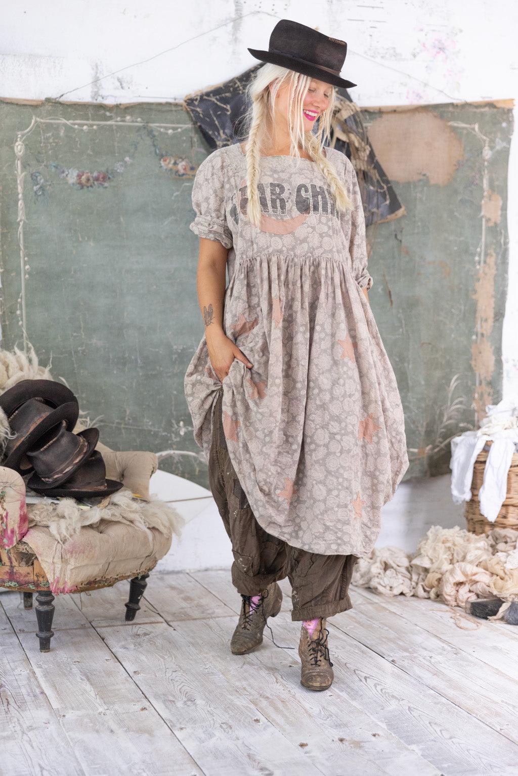 Magnolia Pearl artisan dress with whimsical vintage style, worn by woman in eclectic setting