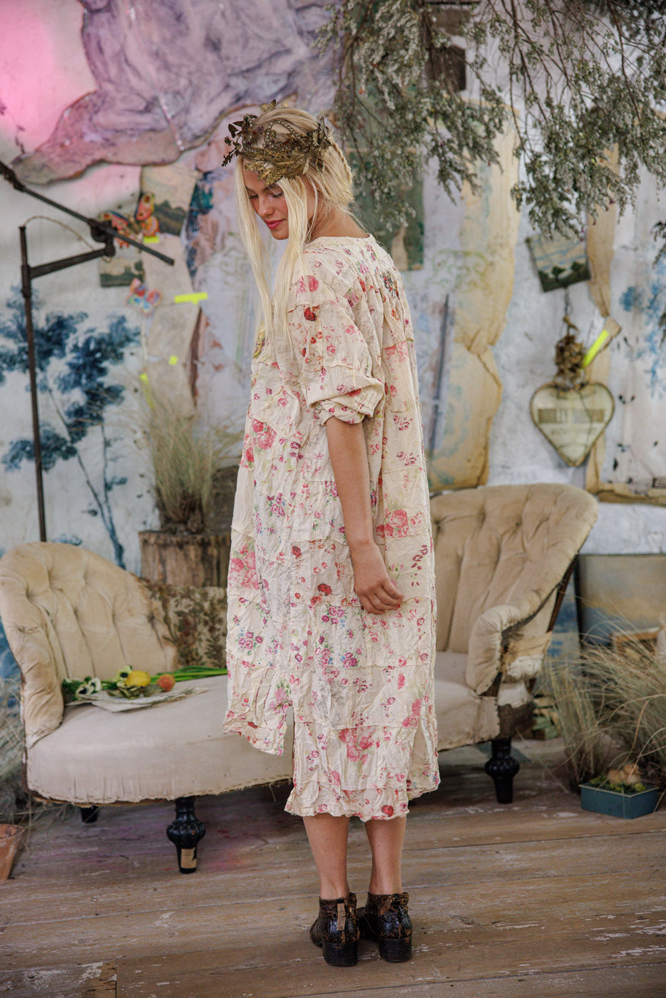 Woman in Magnolia Pearl artisan floral dress with whimsical crown, vintage shabby chic setting