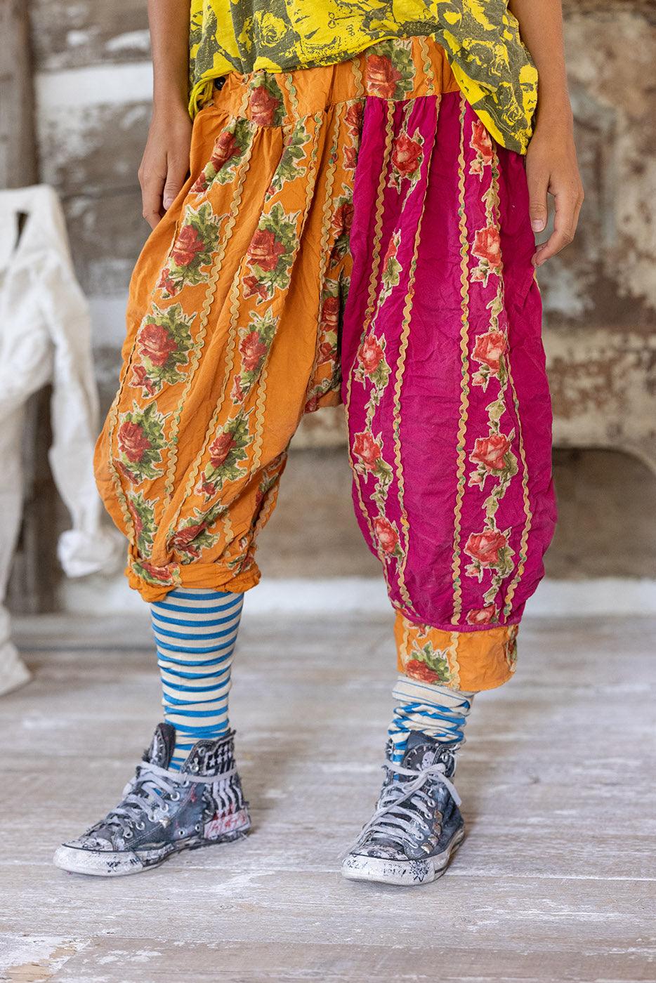 Magnolia Pearl whimsical artisan harem pants with vintage floral patchwork, striped socks, and distressed sneakers