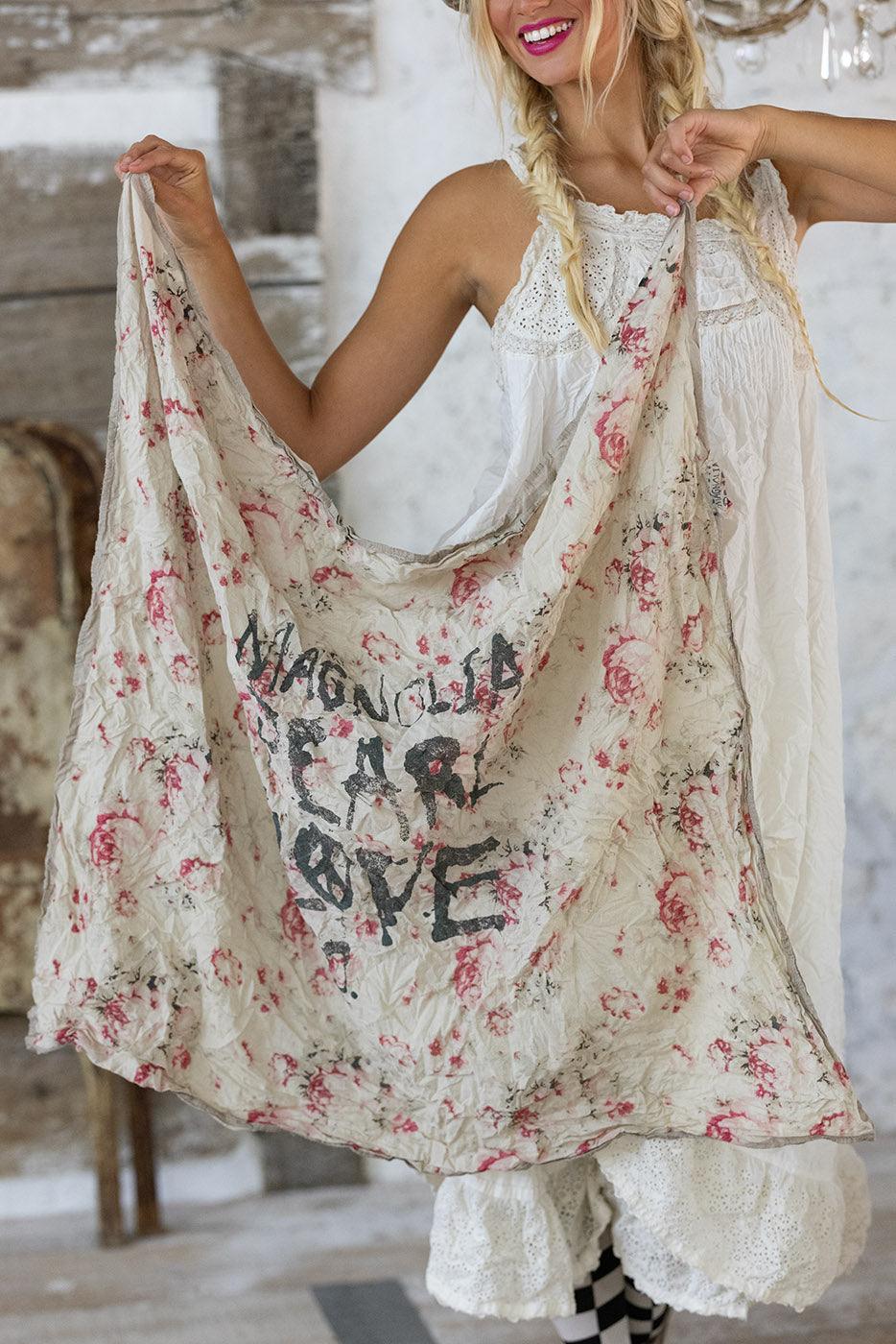 Woman in Magnolia Pearl artisan vintage dress, floral shawl, whimsical hat, eclectic style