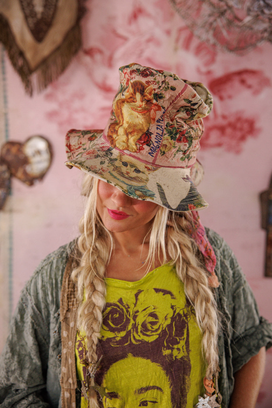 Woman in Magnolia Pearl artisan floral cat hat and whimsical vintage-style outfit