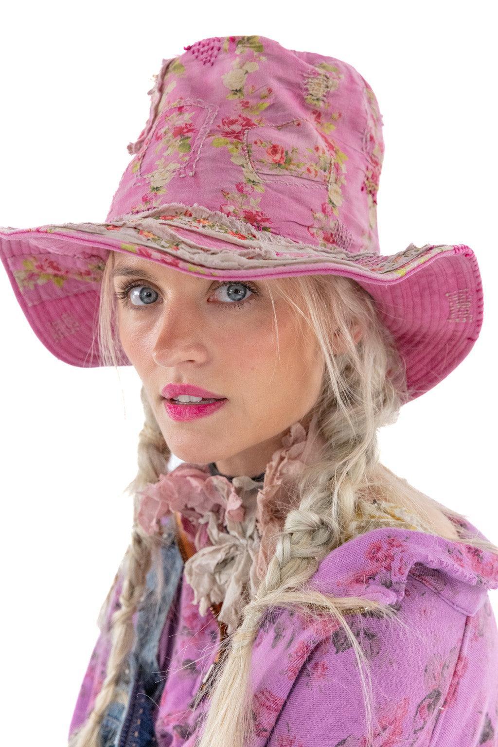 Magnolia Pearl woman in pink floral vintage hat and whimsical artisan jacket, close up
