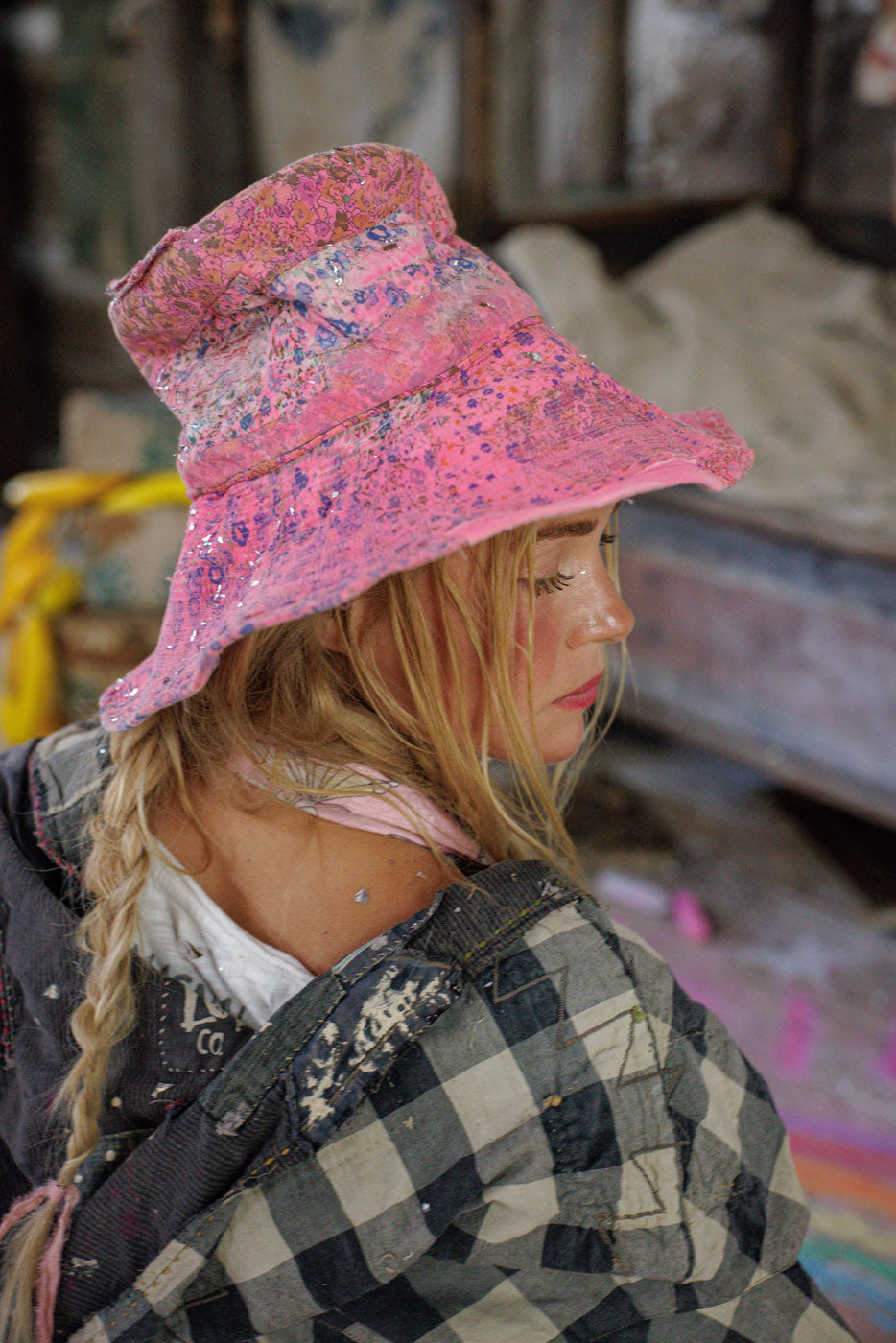 Woman in Magnolia Pearl vintage patchwork jacket and pink artisan floral bucket hat