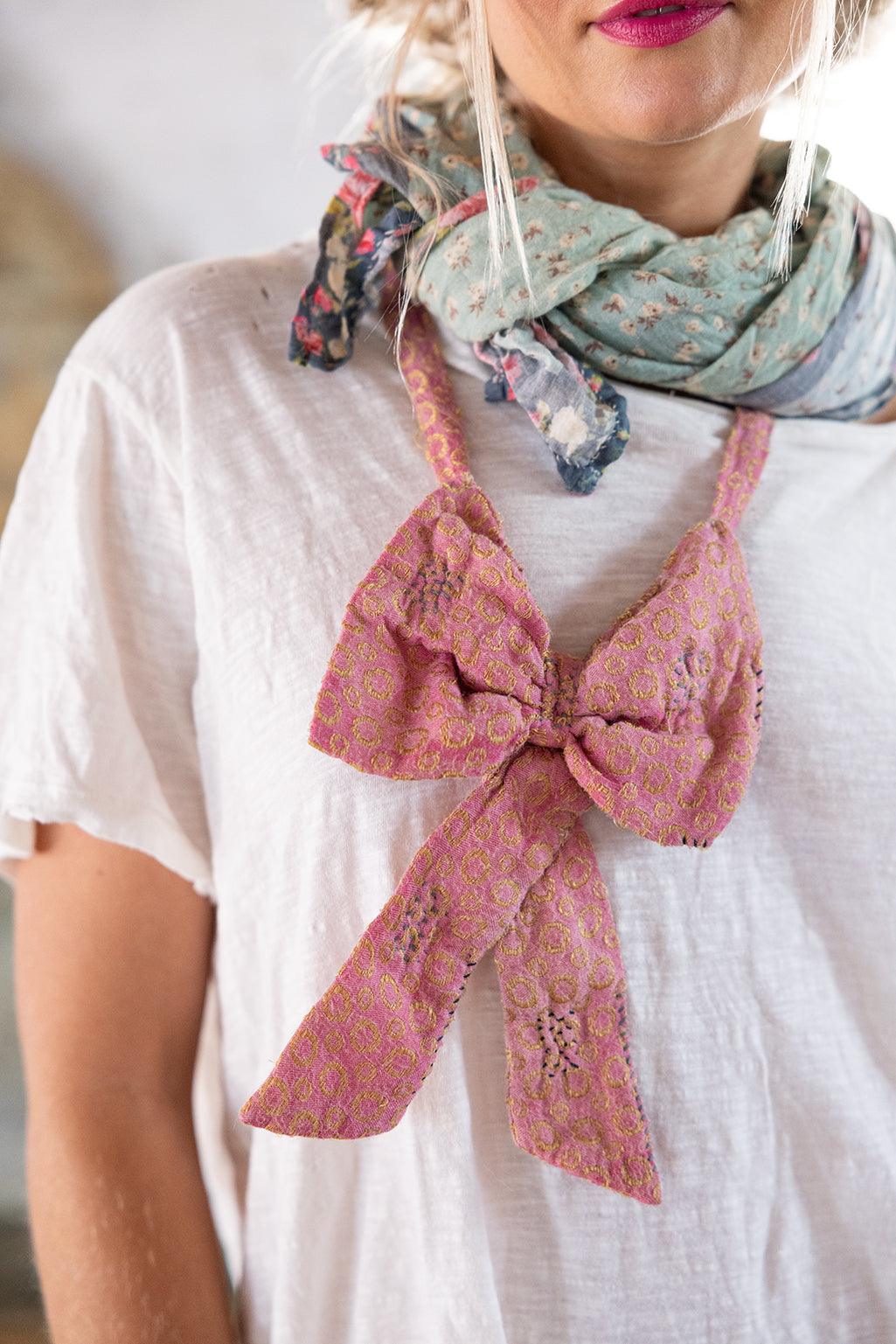 Magnolia Pearl artisan patchwork pants with floral prints, pink bow, vintage boots, whimsical style