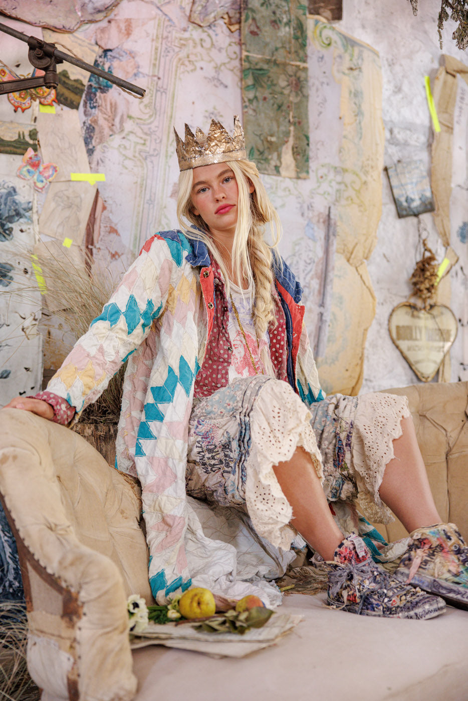 Magnolia Pearl model in patchwork quilt jacket, lace pants, and a crown, vintage whimsical artisan fashion