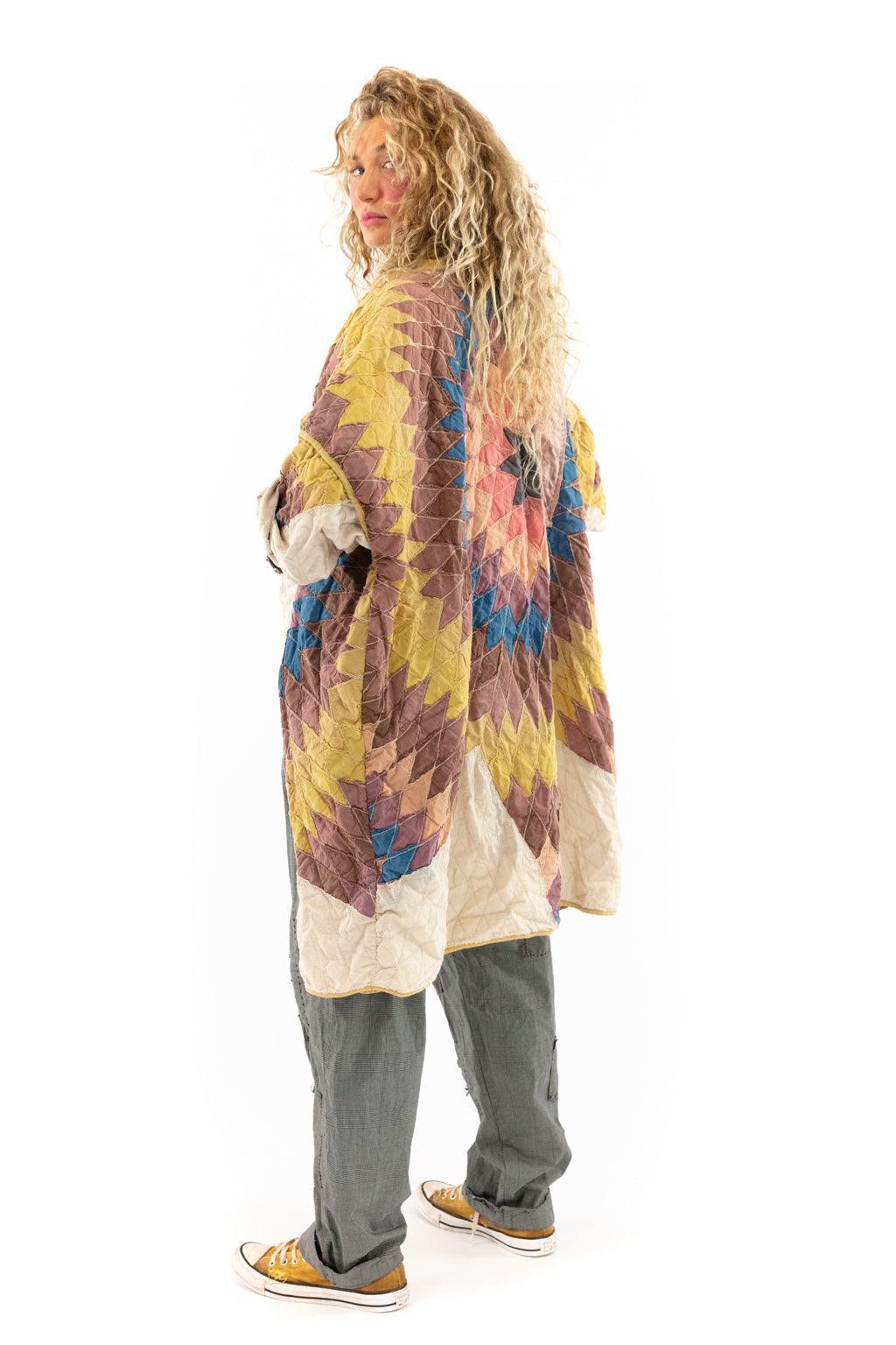Woman modeling Magnolia Pearl artisan patchwork jacket, whimsical vintage style, colorful design