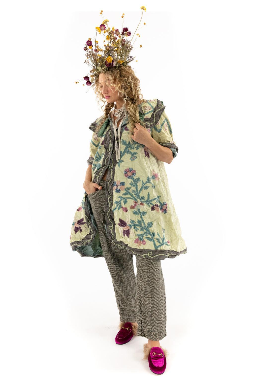 Woman in Magnolia Pearl artisan vintage jacket, floral top hat, whimsical eclectic clothing style