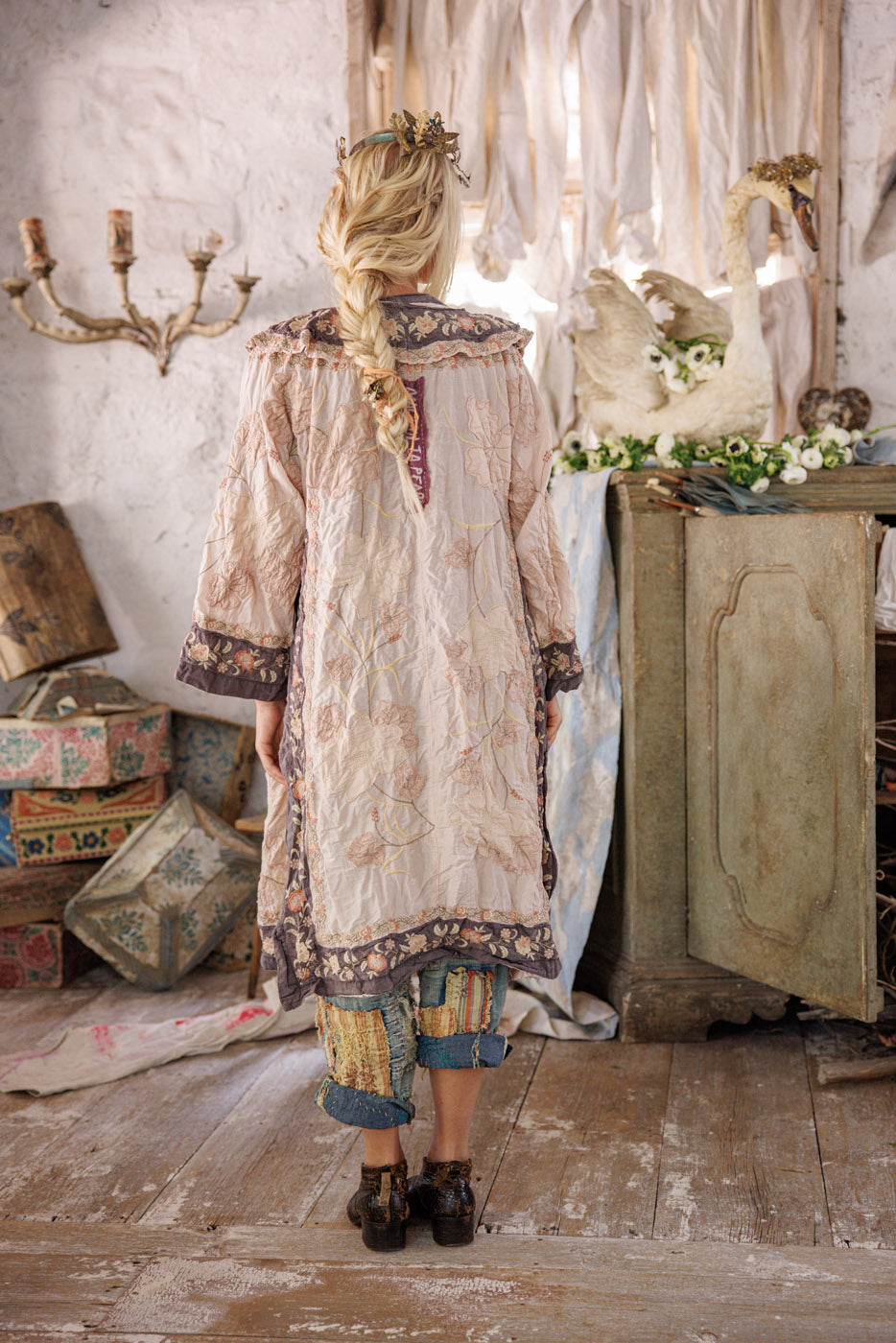 Magnolia Pearl artisan jacket with whimsical vintage floral design, rustic cottage setting