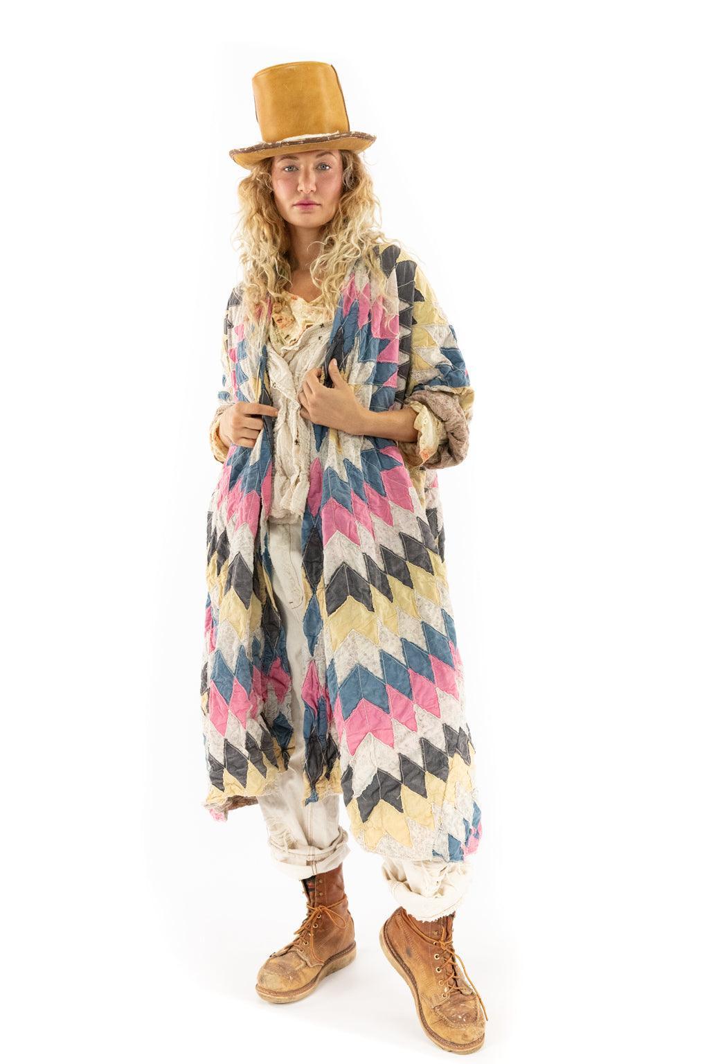 Woman in Magnolia Pearl artisan quilted jacket, vintage top, cream pants, and tan top hat