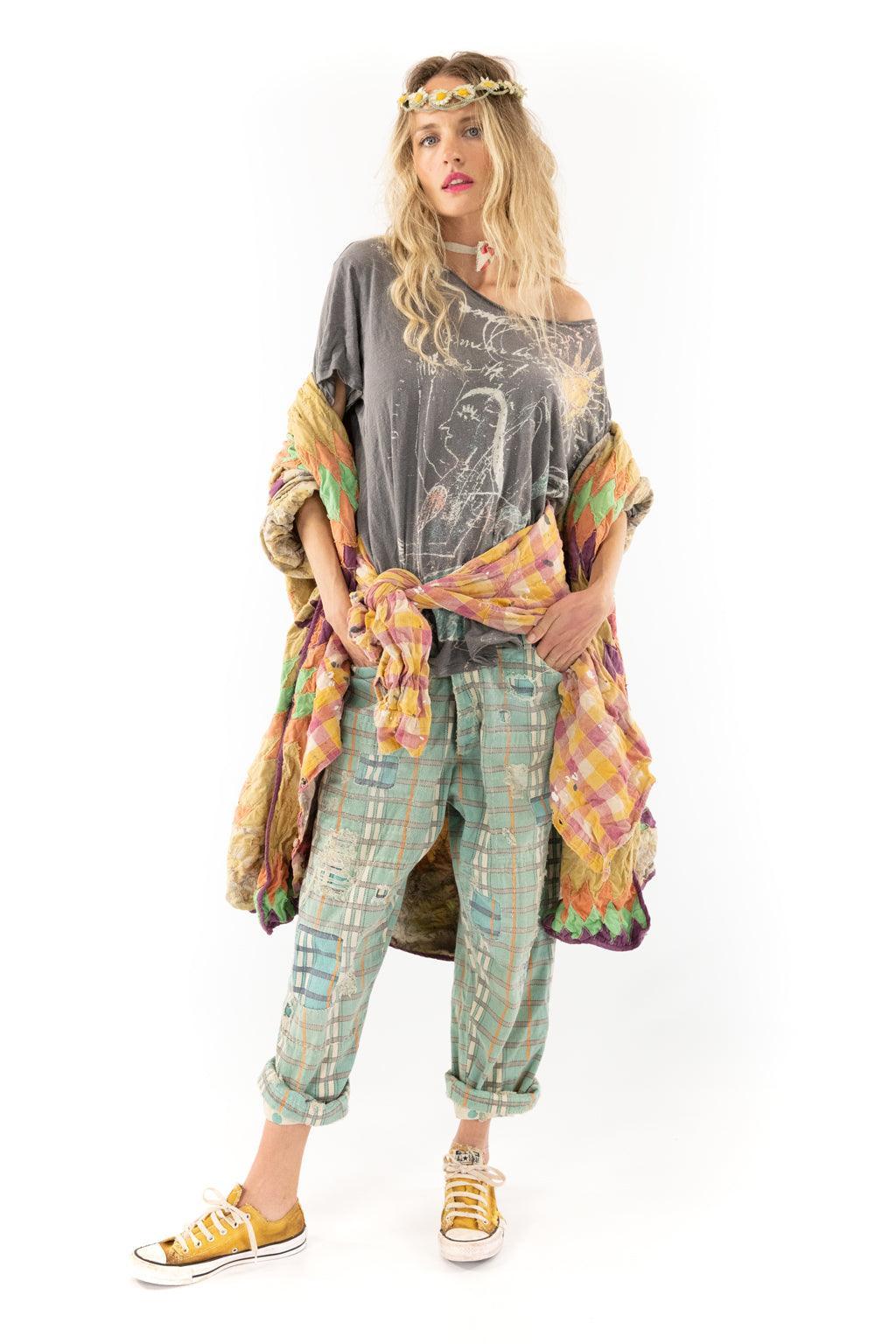 Woman in Magnolia Pearl patchwork jacket, pastel plaid pants, floral headband, vintage boho style