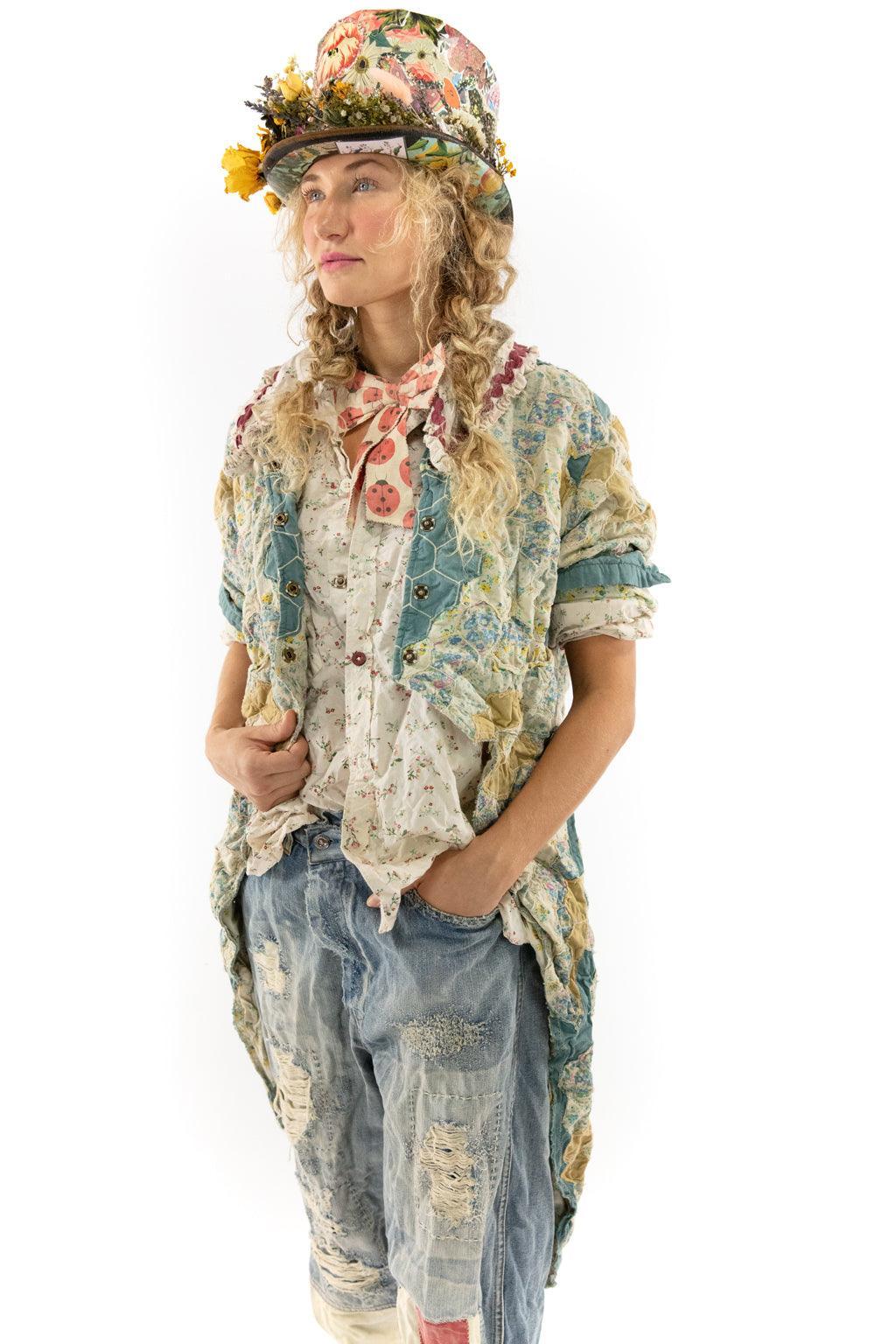 Woman in Magnolia Pearl artisan vintage patchwork jacket and distressed jeans, floral hat, whimsical style