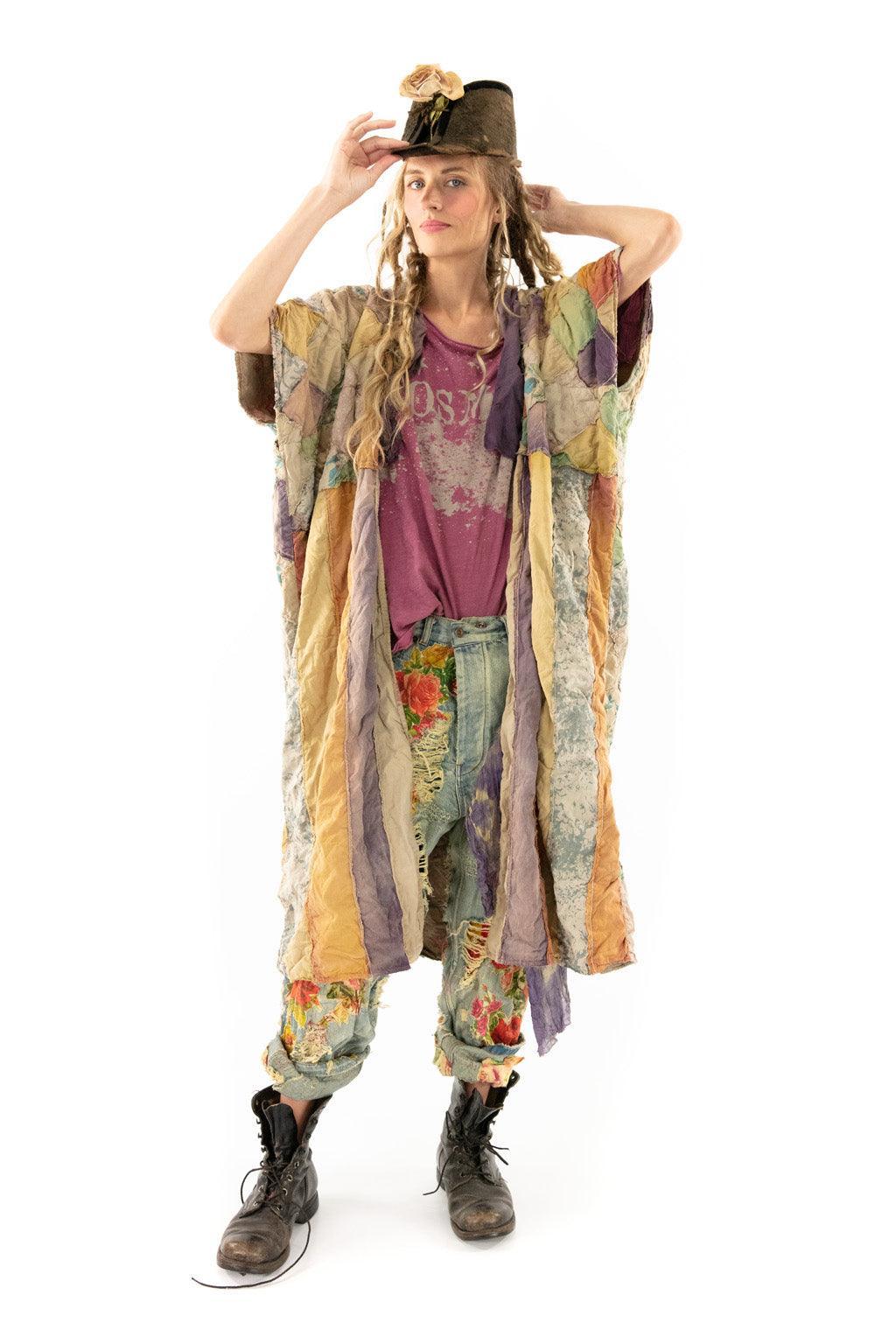 Woman in Magnolia Pearl vintage patchwork jacket, floral distressed jeans, whimsical artisan style