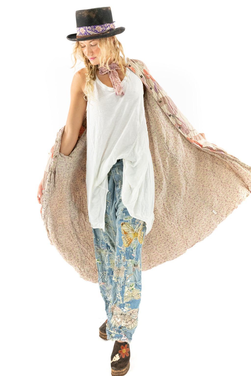 Woman in Magnolia Pearl artisan floral kimono, patchwork jeans, vintage hat and eclectic shoes