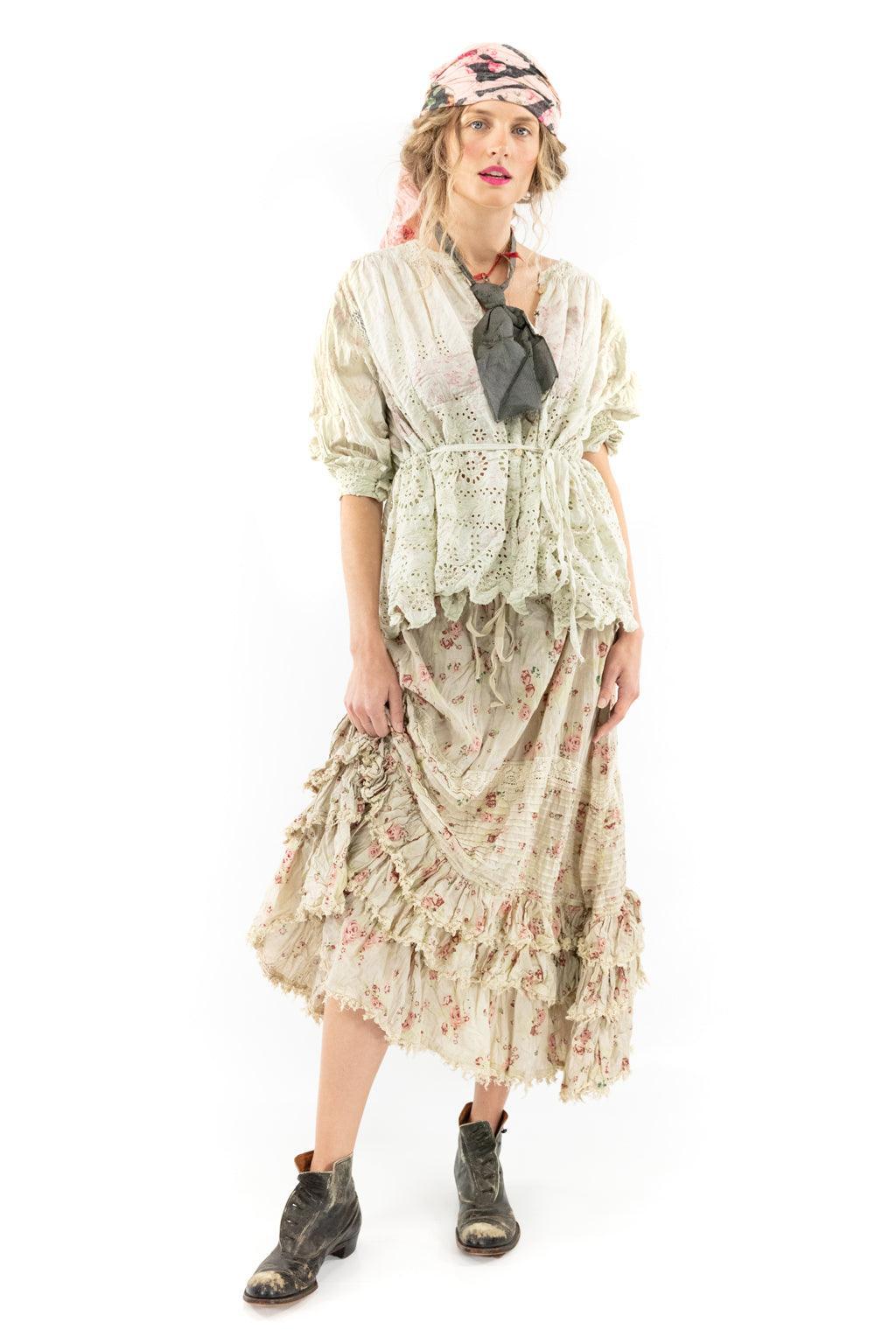 Woman in Magnolia Pearl artisan eyelet blouse and vintage floral skirt with whimsical scarf