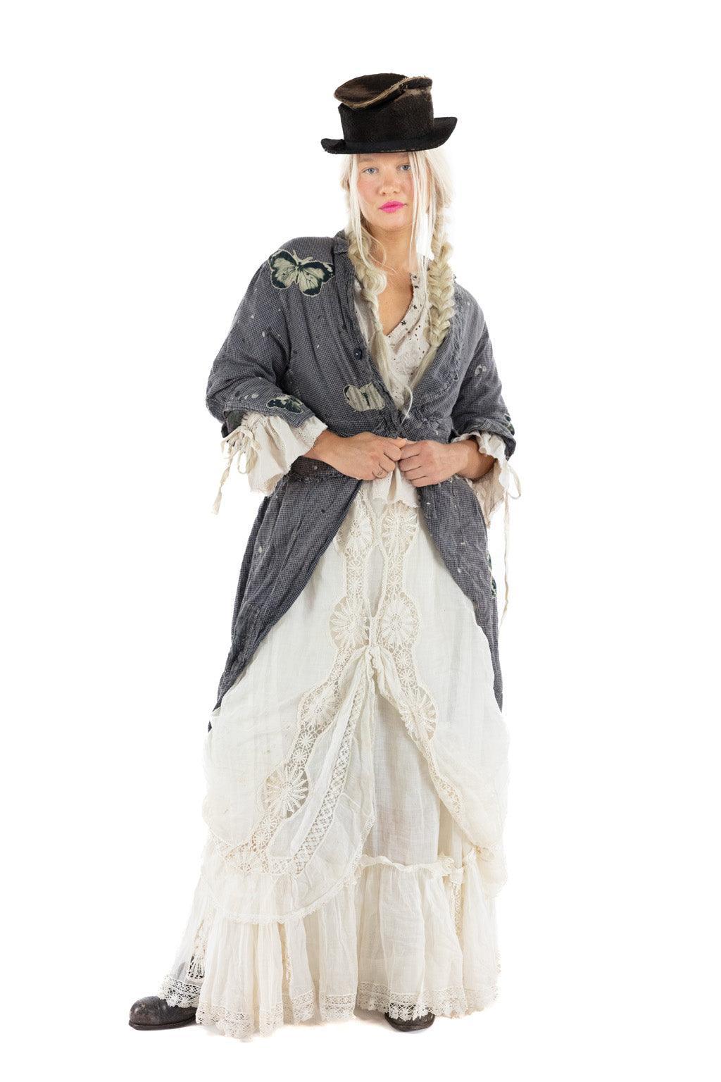 Woman in Magnolia Pearl artisan jacket and vintage lace blouse with whimsical hat