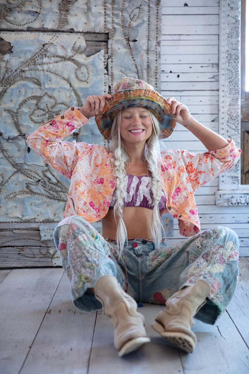 Woman in Magnolia Pearl artisan patchwork hat and floral jacket, vintage boho clothing style