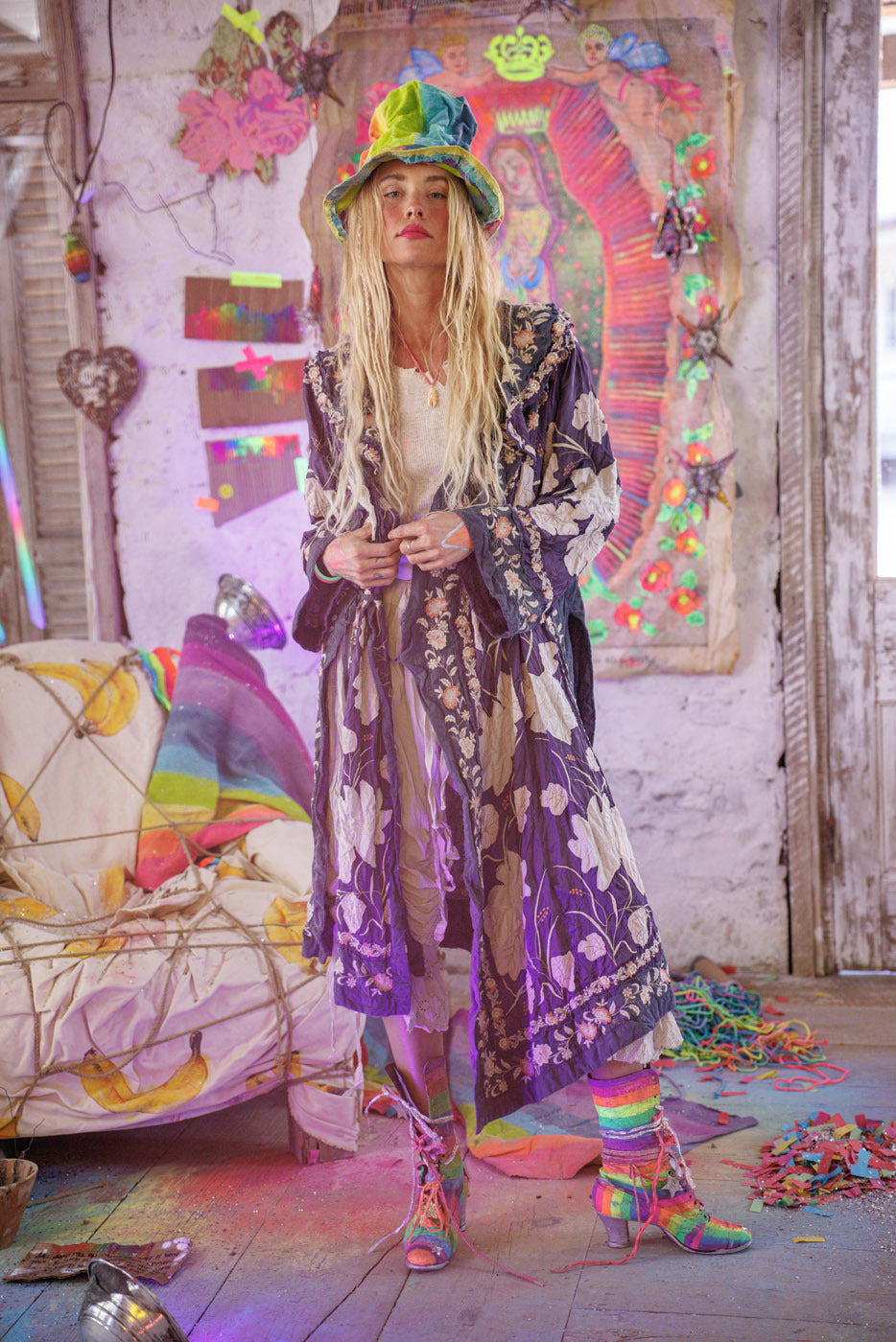 Magnolia Pearl artisan jacket with whimsical floral vintage style, worn by model in colorful, artistic setting