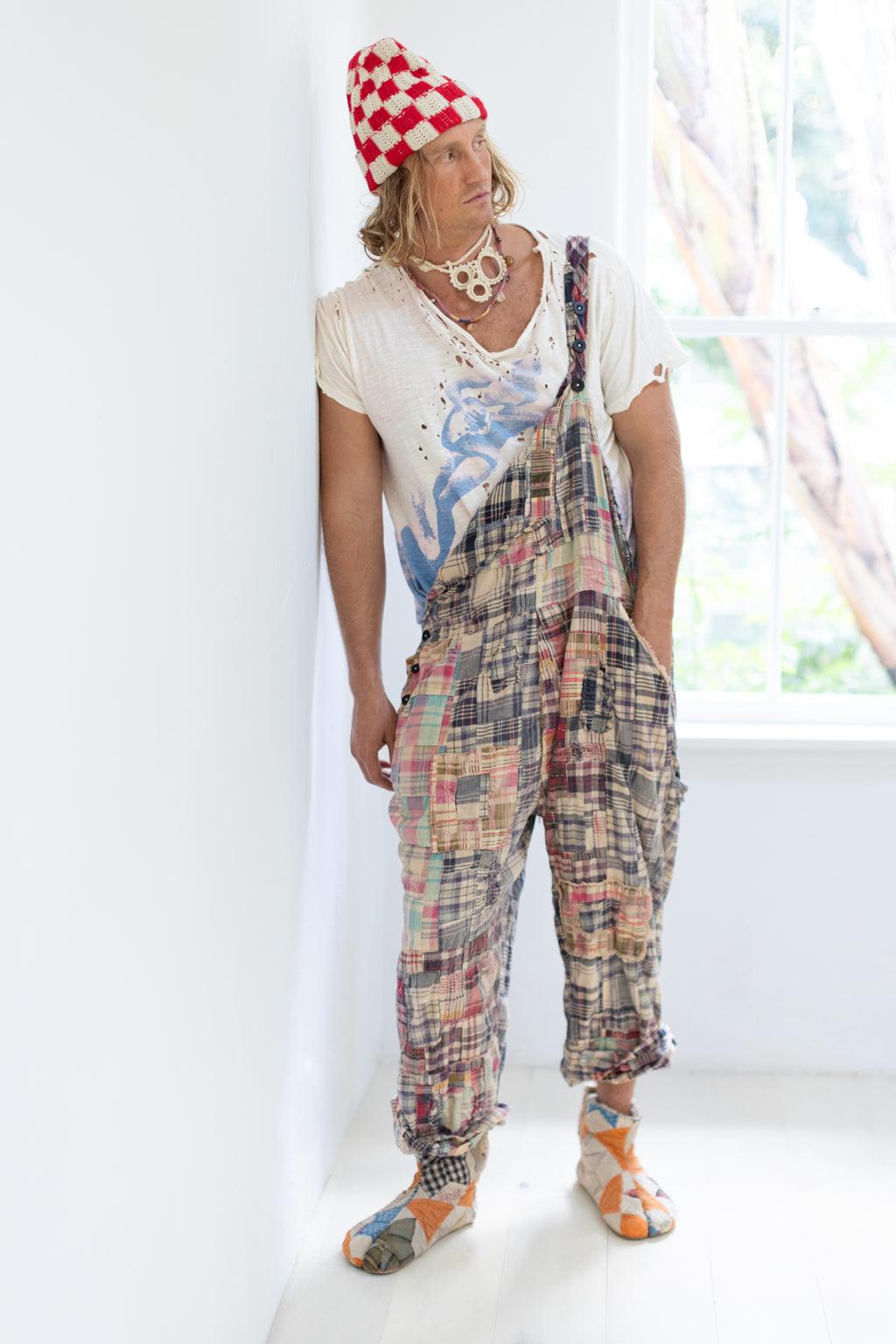 Man in Magnolia Pearl artisan patchwork overalls, distressed tee, whimsical accessories, vintage style