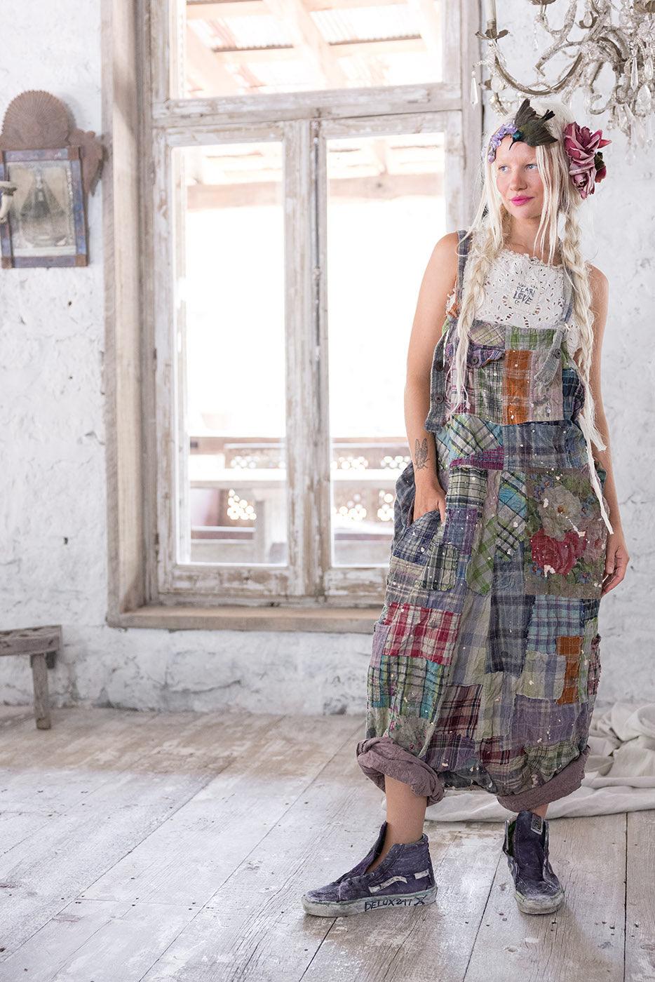 Woman in Magnolia Pearl patchwork overalls, whimsical vintage artisan clothing, rustic room