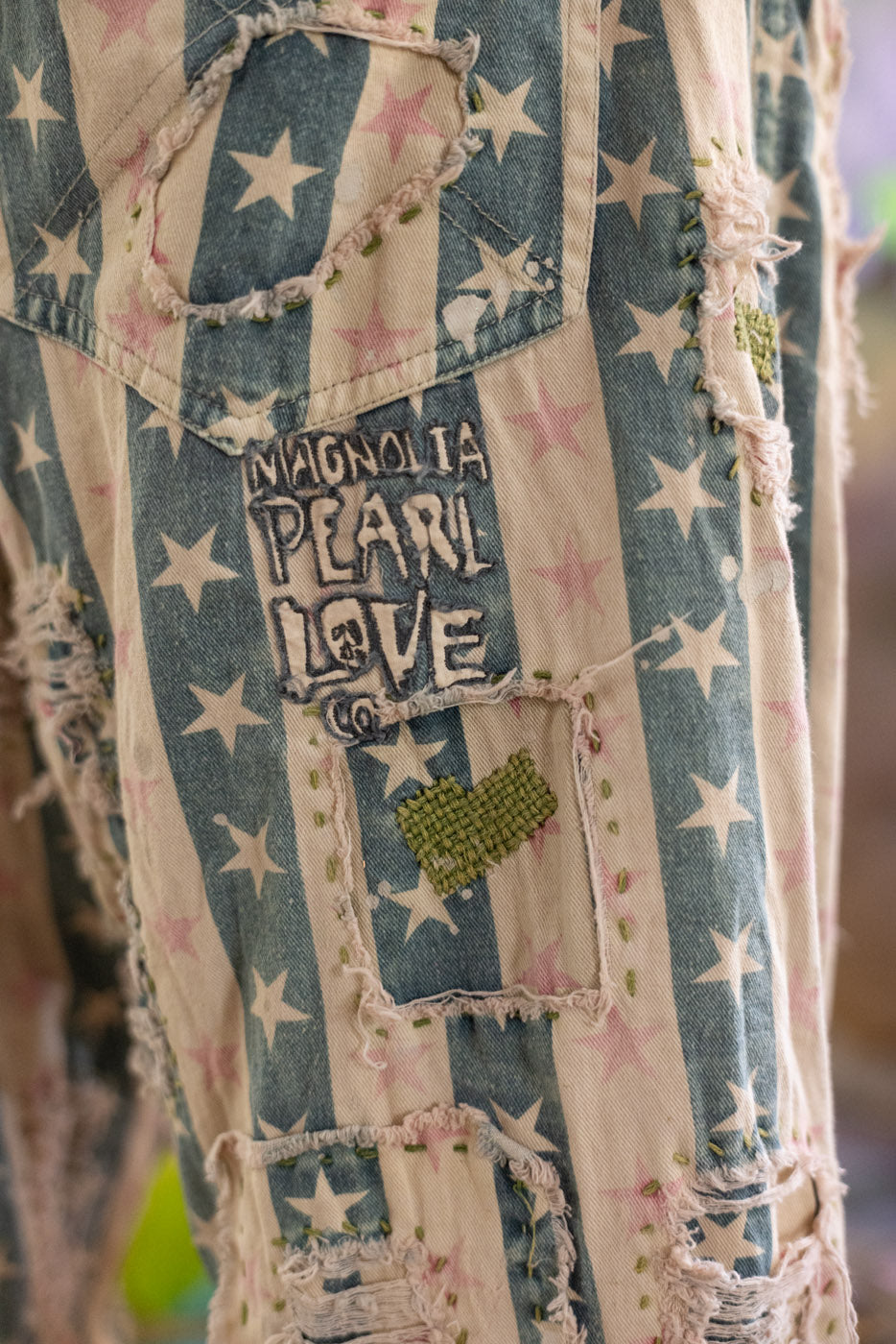 Denim pants with star pattern and 'Magnolia Pearl Love' patch