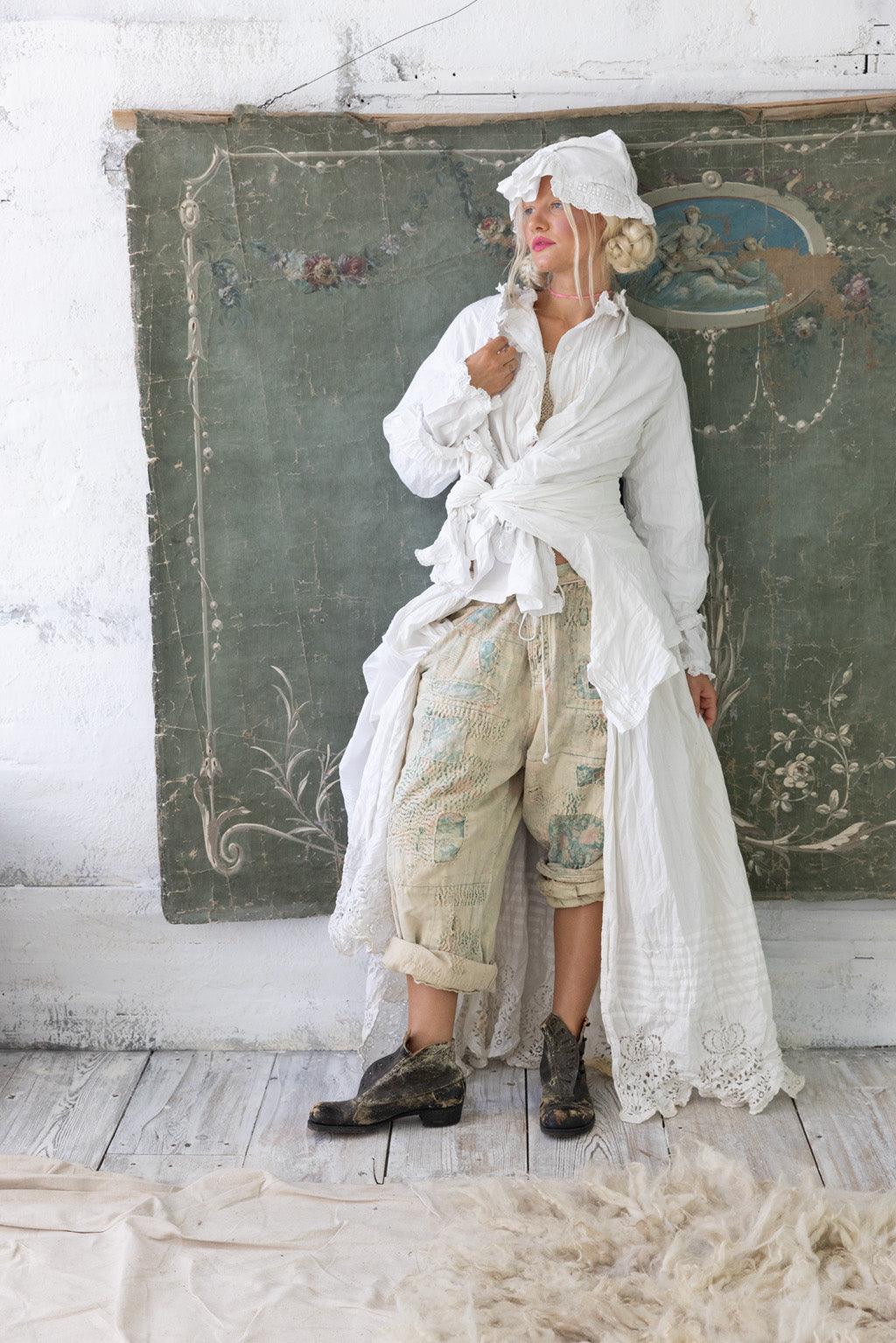 Magnolia Pearl artisan pants with whimsical vintage embroidery, white ruffled coat, rustic boots