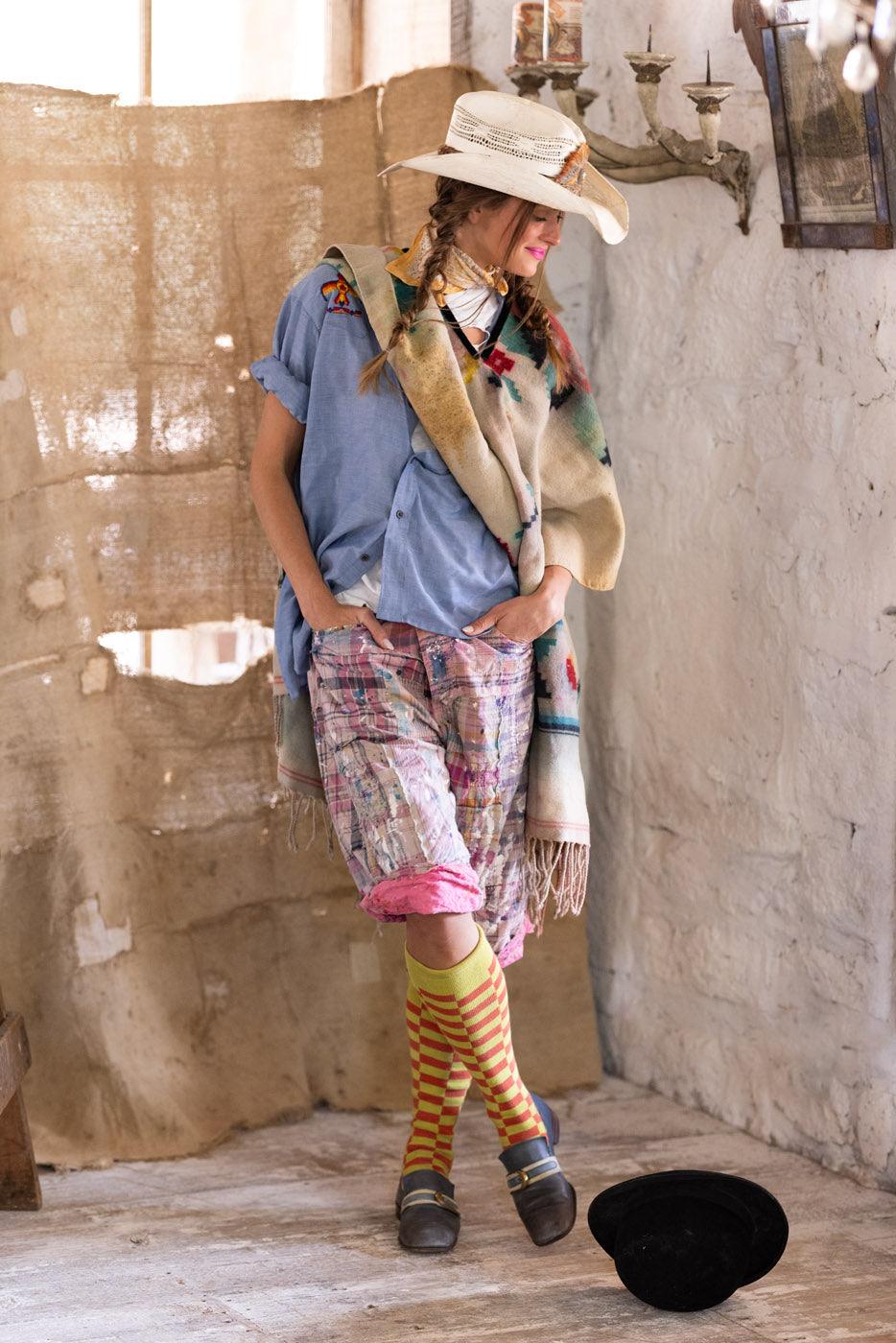 Woman in Magnolia Pearl vintage patchwork shorts, whimsical artisan clothing, rustic room