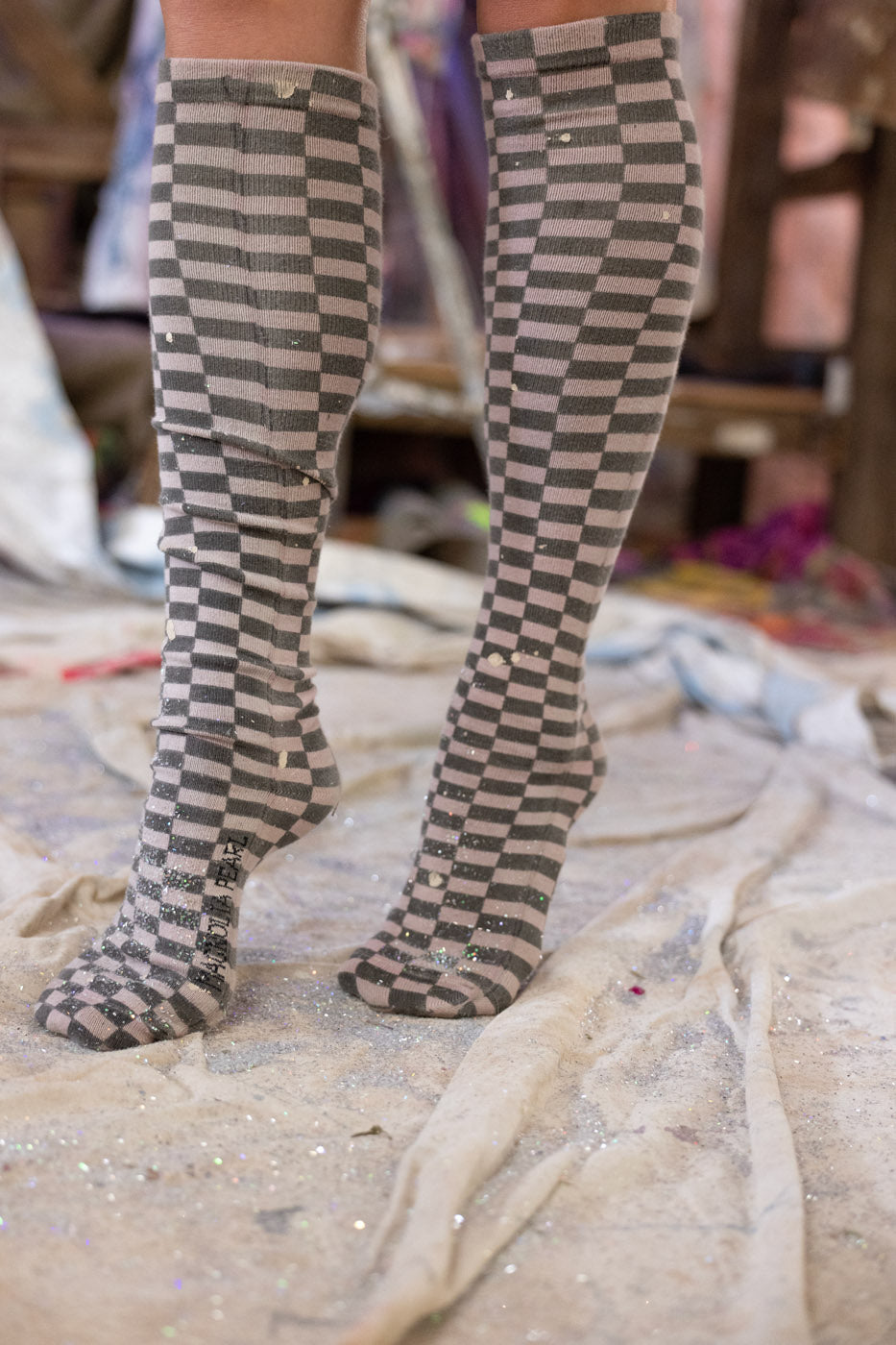 Checkered knee-high cozy soft socks on a blurred background