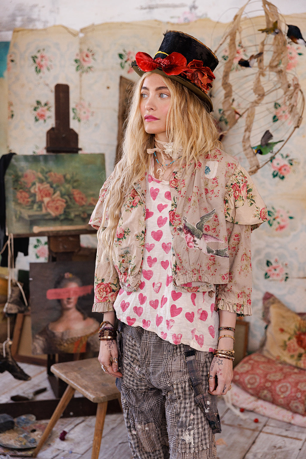 Woman in Magnolia Pearl floral jacket, heart shirt, and top hat, vintage whimsical artisan style