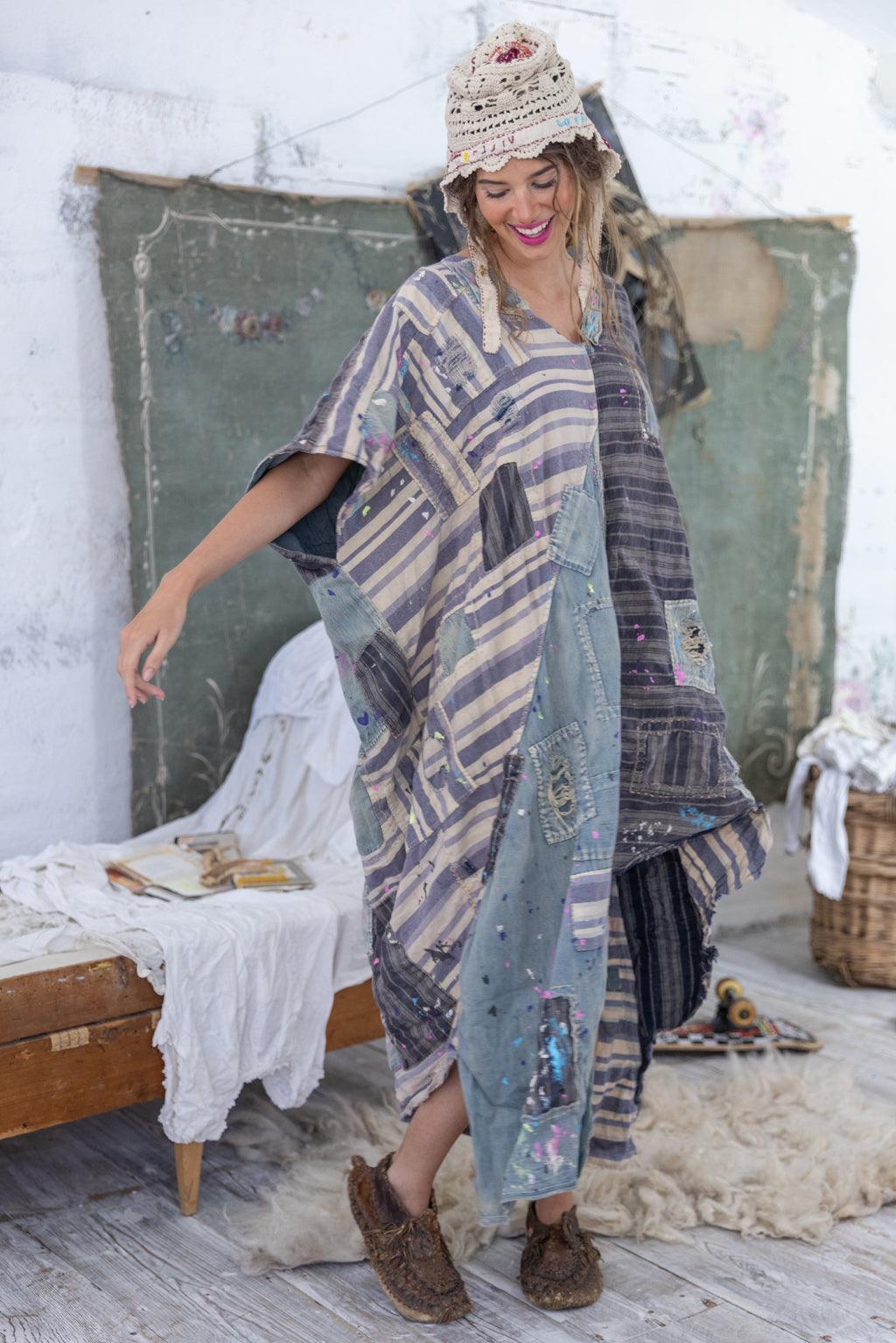 Woman in Magnolia Pearl artisan patchwork dress and crochet hat, vintage whimsical style indoors