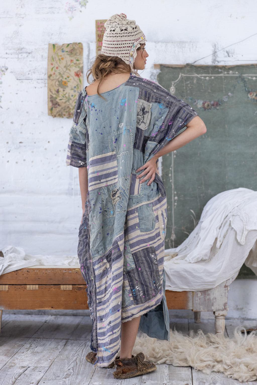 Woman in Magnolia Pearl patchwork artisan dress, vintage rustic room, whimsical style