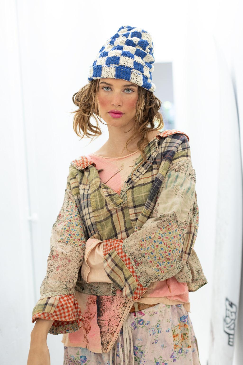 Woman in Magnolia Pearl vintage patchwork artisan top and whimsical blue knit hat