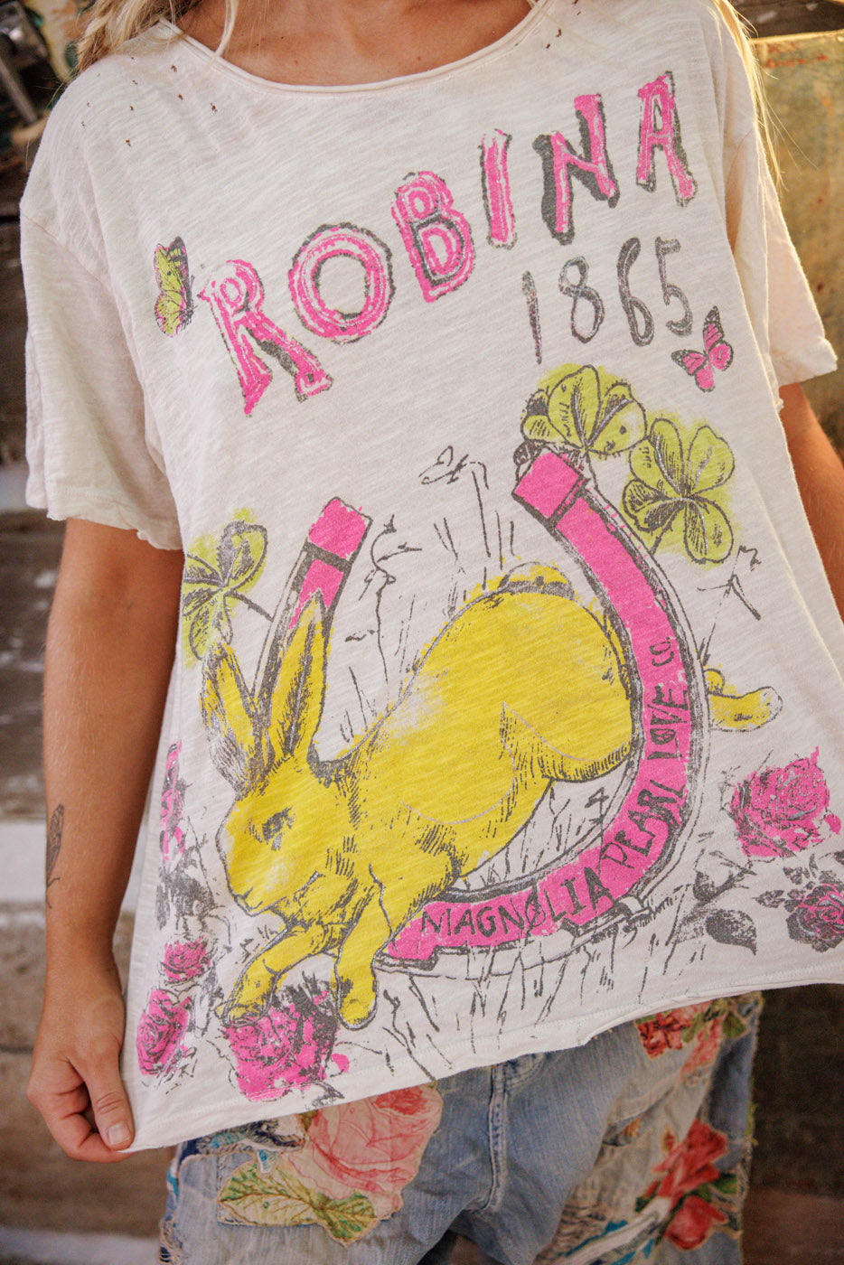 Lucky Anna T Magnolia Pearl Clothing Clovers, Butterflies, Roses, Rabbit, Horseshoe, “Robina 1865” “Magnolia Pearl Love Co.” Graphics on Front