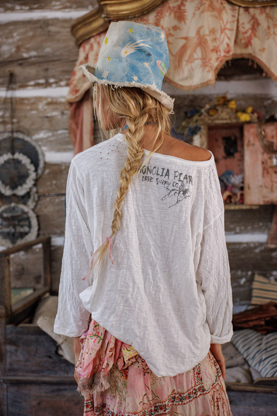 Woman in Magnolia Pearl artisan top and whimsical hat, vintage boho clothing style, rustic decor