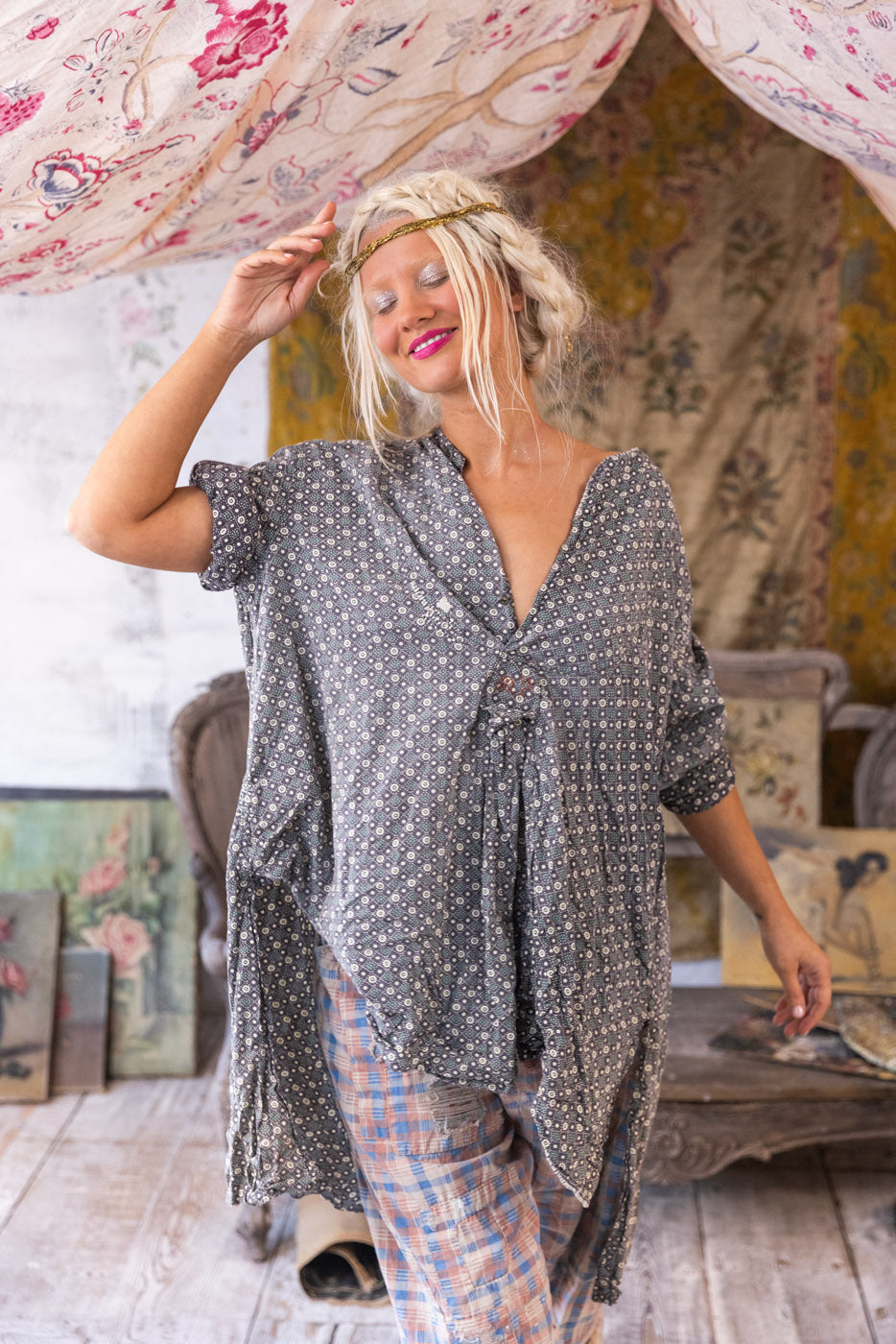 Woman in Magnolia Pearl artisan clothing, whimsical vintage style, eclectic studio decor