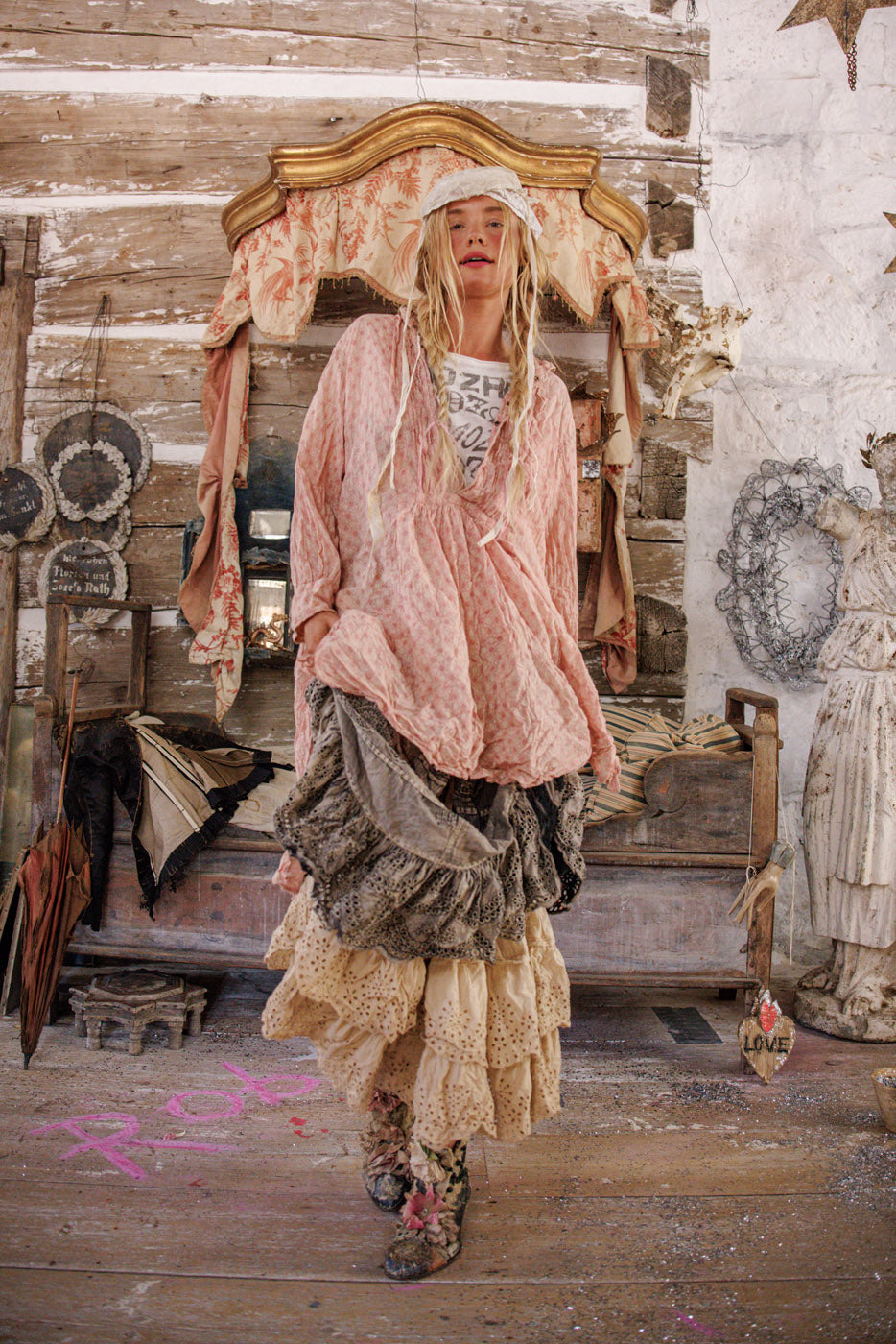 Magnolia Pearl artisan clothing, woman in whimsical vintage layered dress, rustic cottage setting