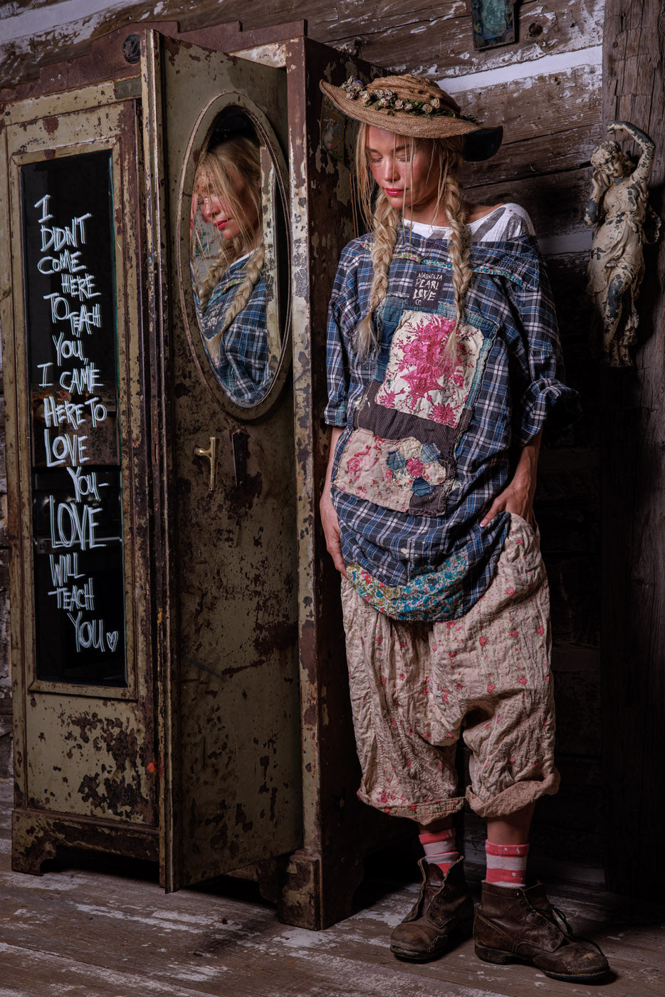 Magnolia Pearl model in vintage artisan patchwork clothing, straw hat, rustic setting, whimsical style