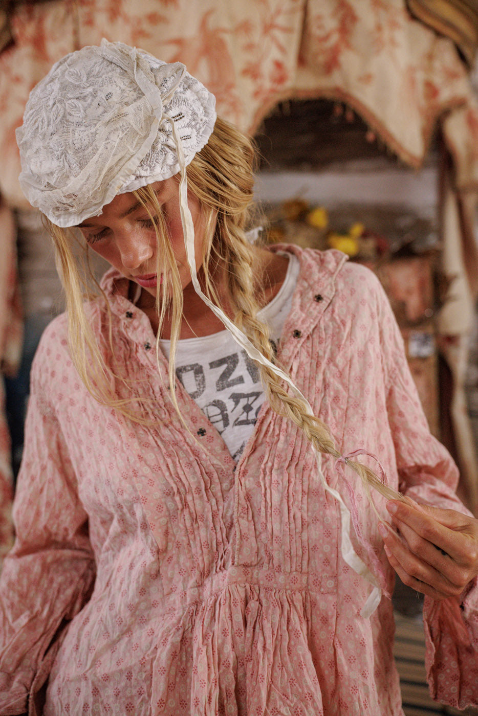 Woman in Magnolia Pearl artisan vintage pink blouse and lace bonnet, whimsical farmhouse style