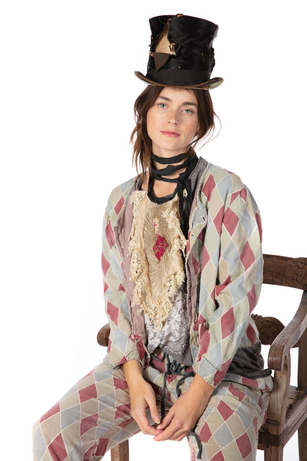 Woman in Magnolia Pearl vintage harlequin artisan clothing with whimsical lace bib and distressed top hat