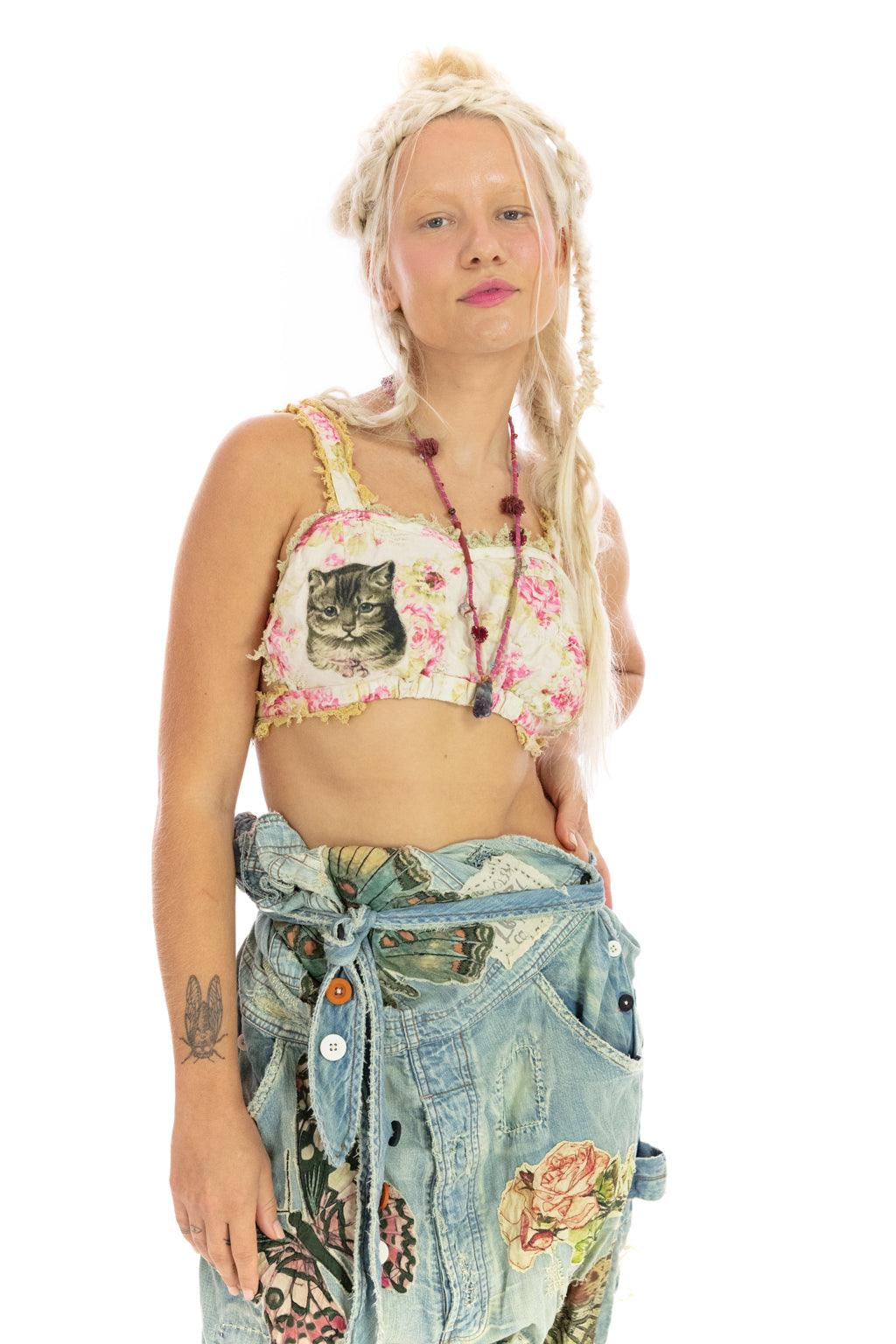 Woman in Magnolia Pearl artisan crop top with cat print, floral design, and butterfly denim pants