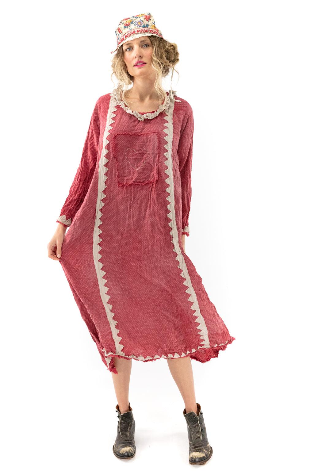 Woman in Magnolia Pearl artisan vintage red dress with whimsical zigzag trim, floral hat, boots