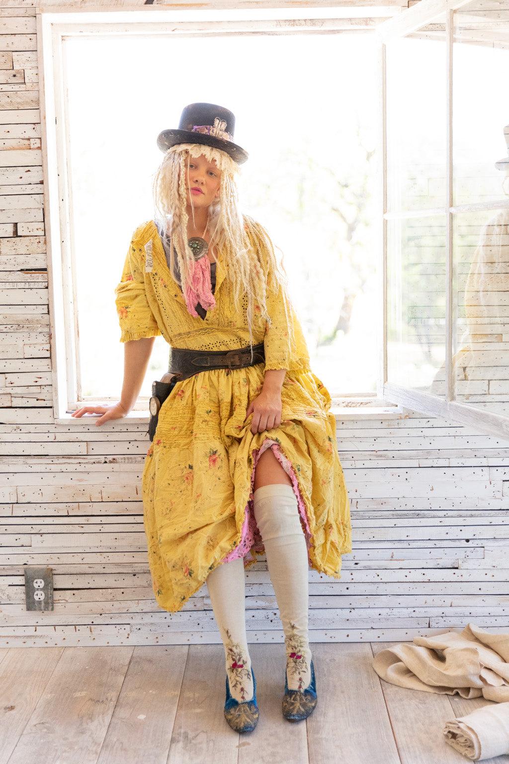 Woman in Magnolia Pearl yellow vintage artisan dress, top hat, whimsical eclectic style