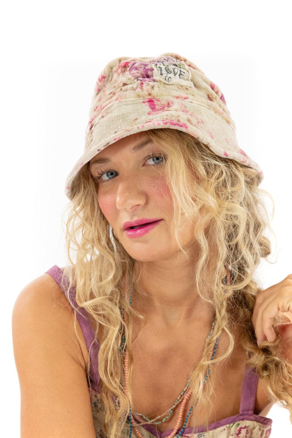 Woman wearing Magnolia Pearl artisan bucket hat with whimsical vintage floral design