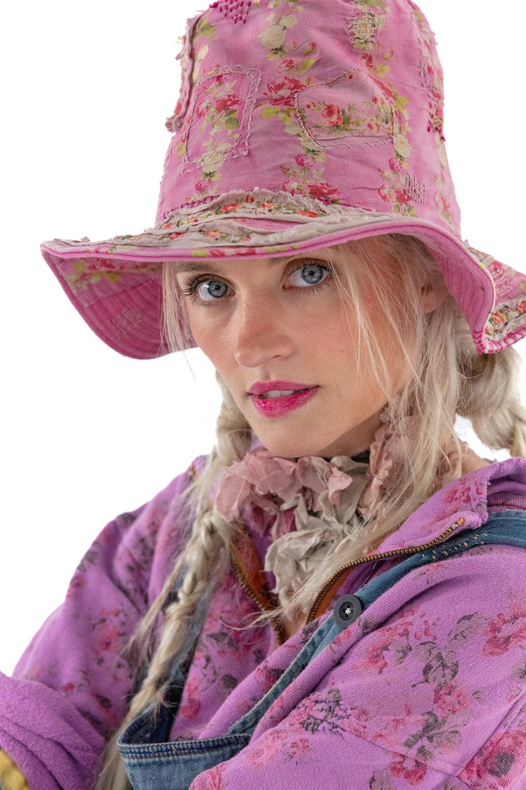 Magnolia Pearl woman in pink floral vintage hat and whimsical artisan jacket, close up