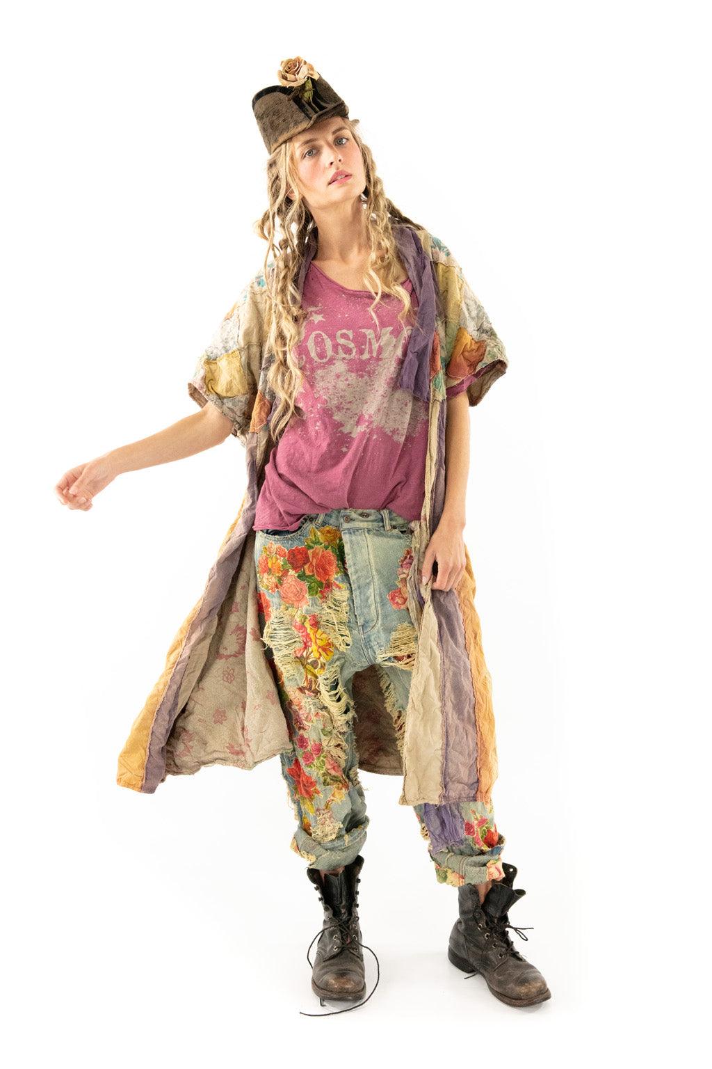 Woman in Magnolia Pearl vintage patchwork jacket, floral distressed jeans, whimsical artisan style