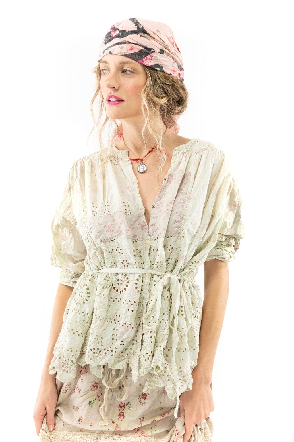 Woman in Magnolia Pearl artisan eyelet blouse and vintage floral skirt with whimsical scarf